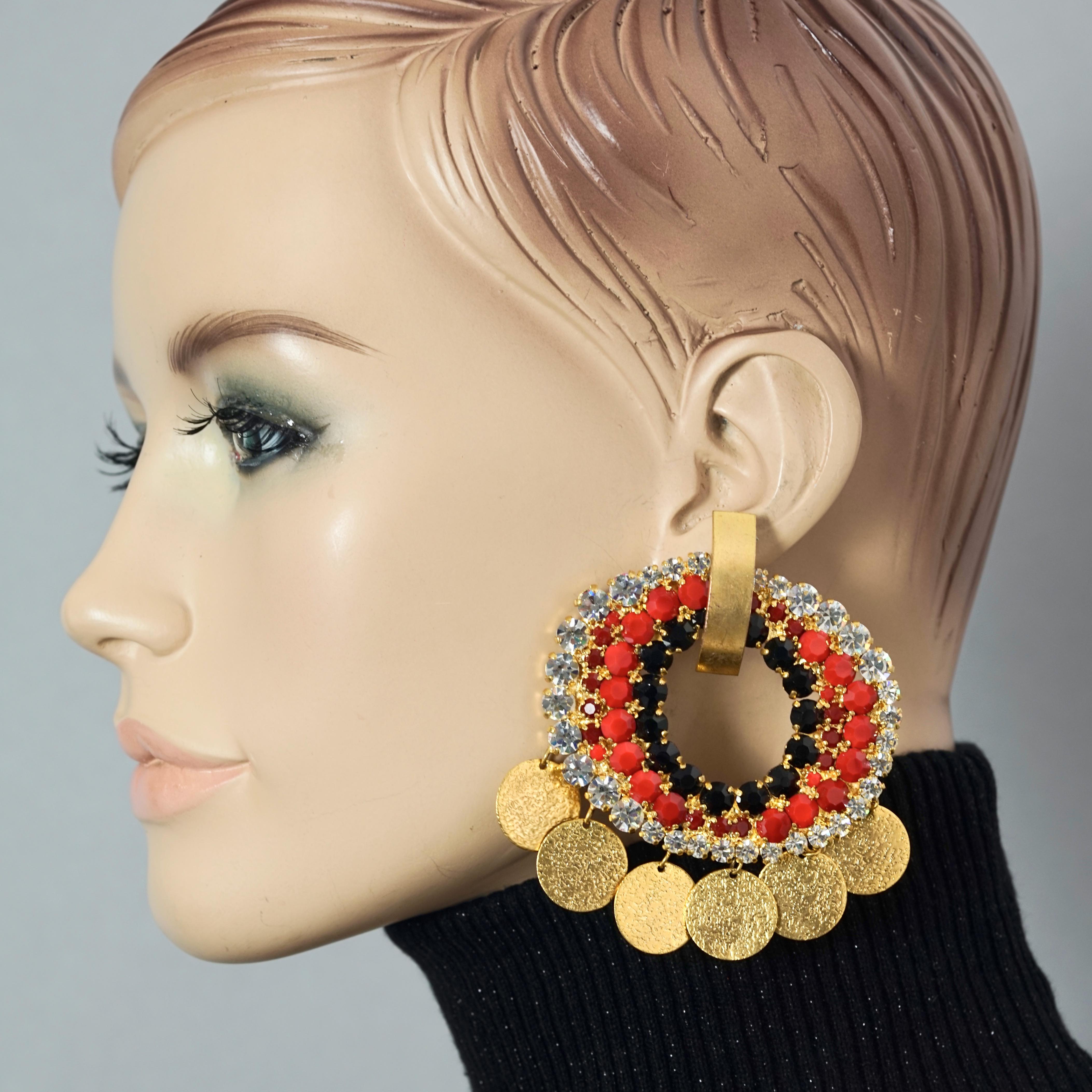 Vintage French Mogul Rhinestone Disc Charm Creole Hoop Earrings

Measurements:
Height: 3.15 inches (8 inches)
Width: 3.22 inches (8.2 inches)
Weight per Earrings: 38 grams

Features:
- Massive French dangling hoop earrings with disc charms.
-