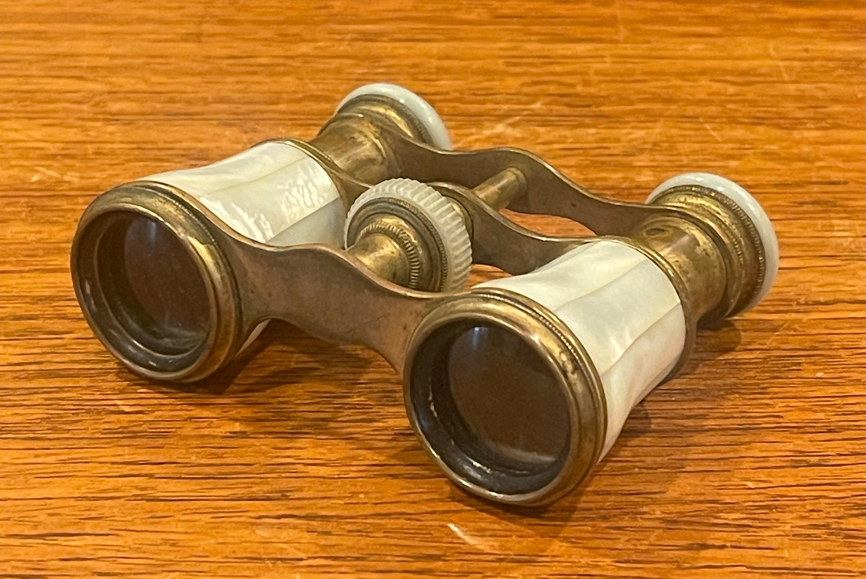 Fabulous vintage French mother-of-pearl and brass opera glasses by LeClaire of Paris, circa 1950s. #2727

Complete functional glasses, the lenses may need some cleaning but this does not affect the clear view; focus bar works great. This stunning