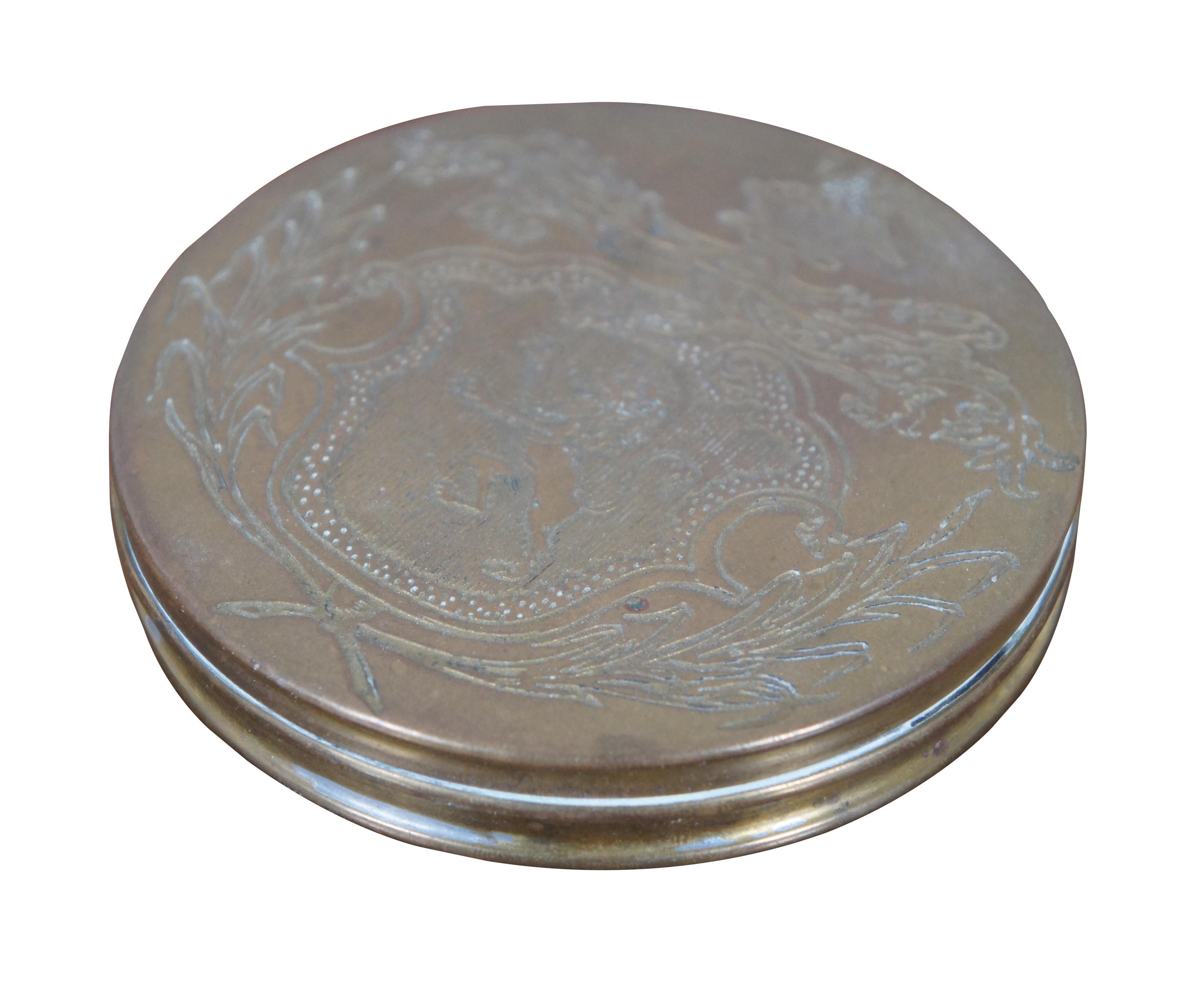 Vintage reproduction brass snuff / trinket / pill box engraved with a coat of arms featuring a lion passant rearing on a shield or crest, surrounded by wheat sheaves, foliate leaves, and a swan on a nest; marked WM Adaptation. 

Province
Estate