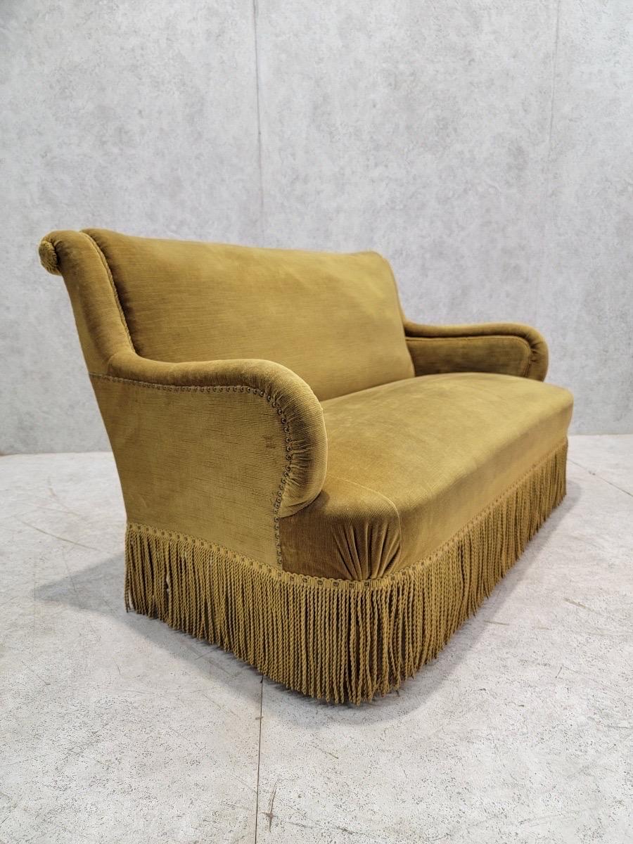 Vintage French Napoleon III Style Scroll Back Petite Sofa

This vintage French petite sofa is upholstered in its original goldish-green mohair. A thick fringe covers its wooden legs. This sofa would be a cozy addition to any living room. 

Circa