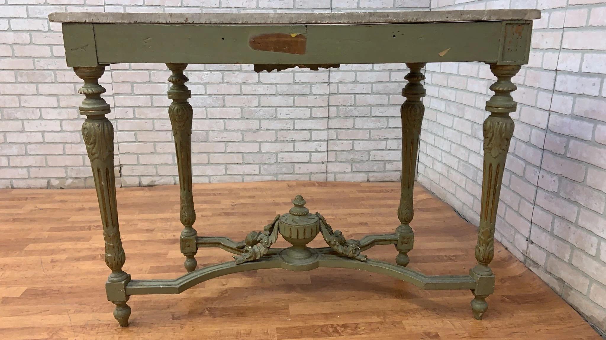 Vintage Opulent French Neoclassical Green Painted Console with Italian Carrara Marble Top

Elevate your decor with this opulent French Neoclassical console table. This finely carved masterpiece features a striking green painted finish adorned with