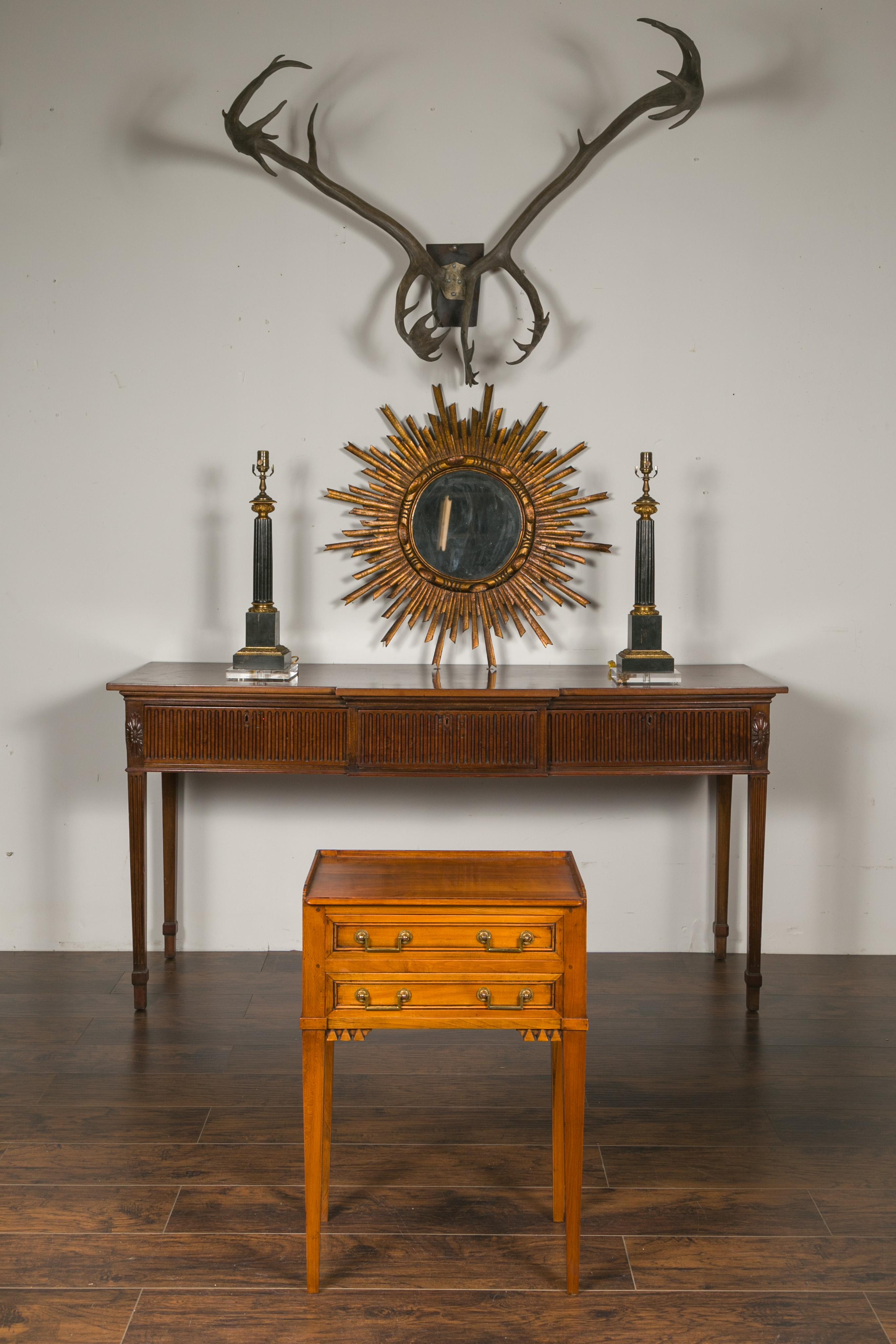 A vintage French neoclassical style walnut bedside table from the mid-20th century, with three-quarter gallery, two drawers and carved motifs. Created in France during the mid-century period, this walnut side table features a rectangular top