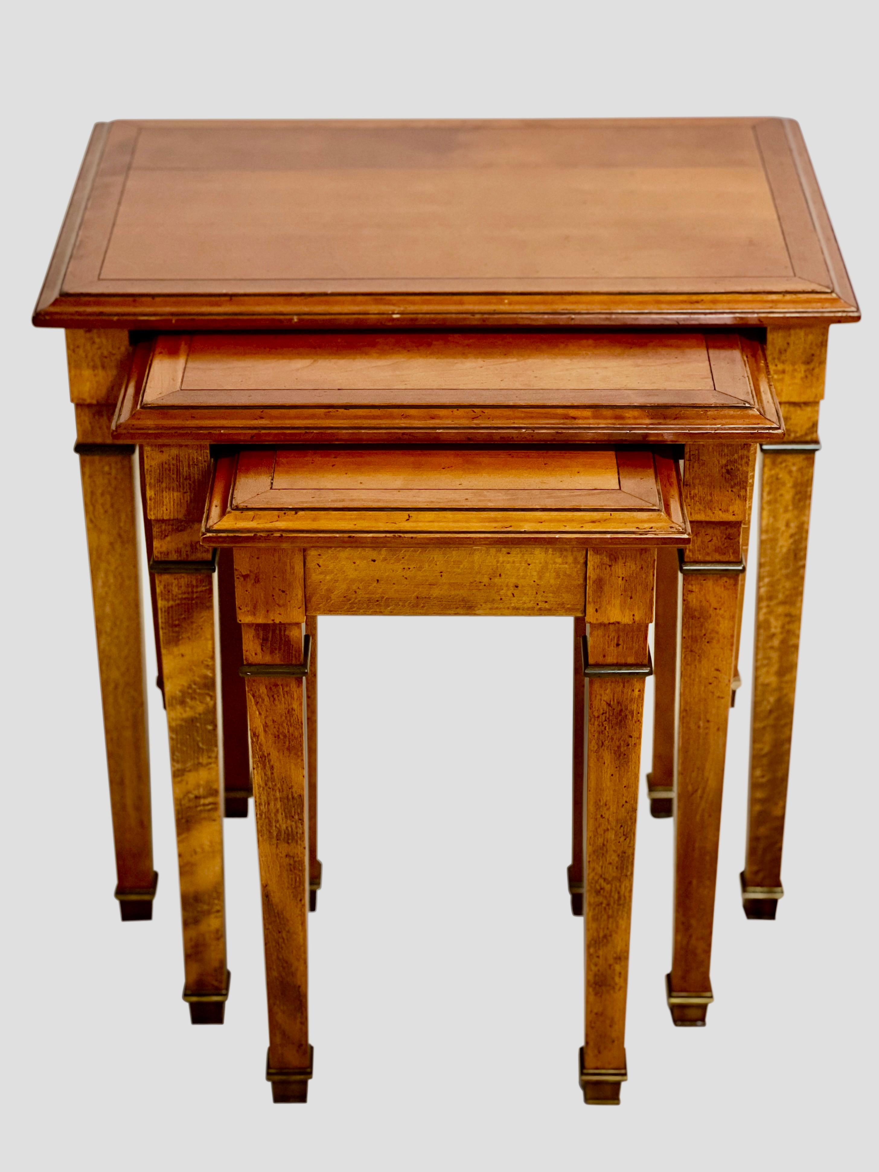 Vintage French Directoire nesting tables by Grange, France, 2000.

Reminiscent of 17th century châteaux in Provence, France, this stately set exemplifies the expert craftsmanship known of Grange since 1904. The tables feature rich cherrywood with