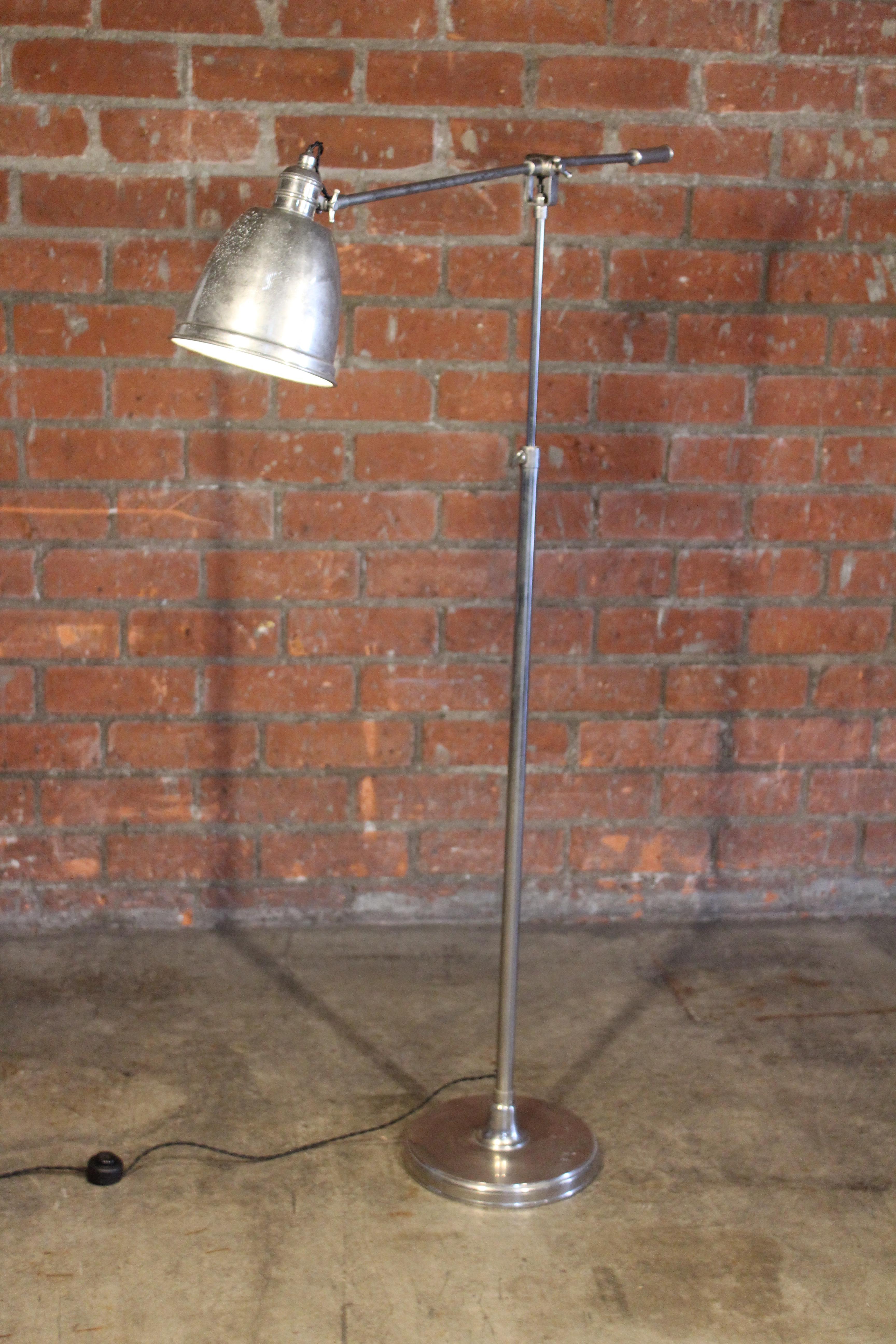A vintage nickel plated adjustable reading floor lamp, France, 1940s. Newly rewired for U.S standards. In good condition with patina to the finish.