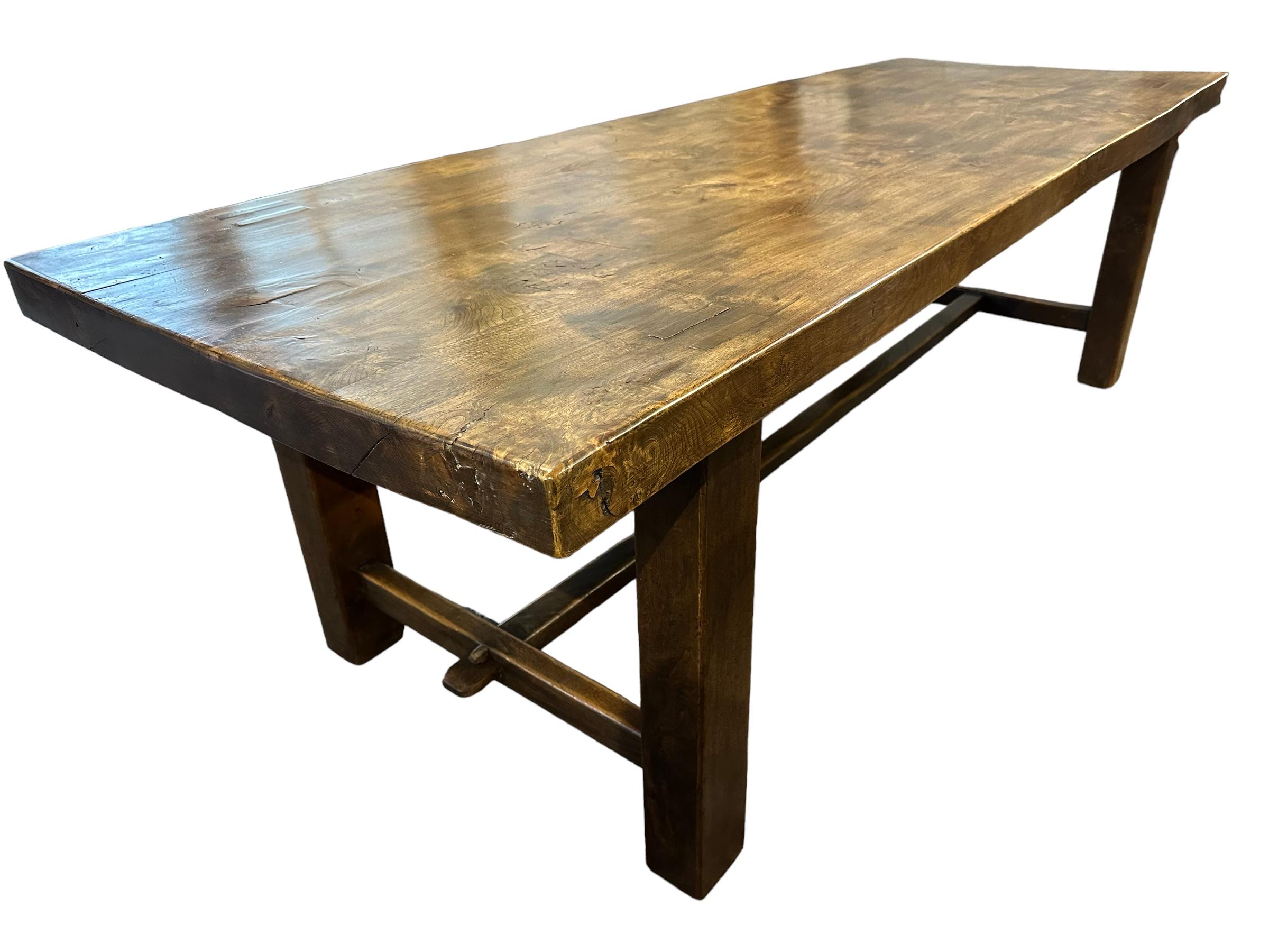 The vintage French elm Normandy table is a great example of a true Normandy table. The sturdy base and good proportions make it a desirable piece of furniture. the lovely dark elm with exquisite figuring on the top adds to its charm. The table