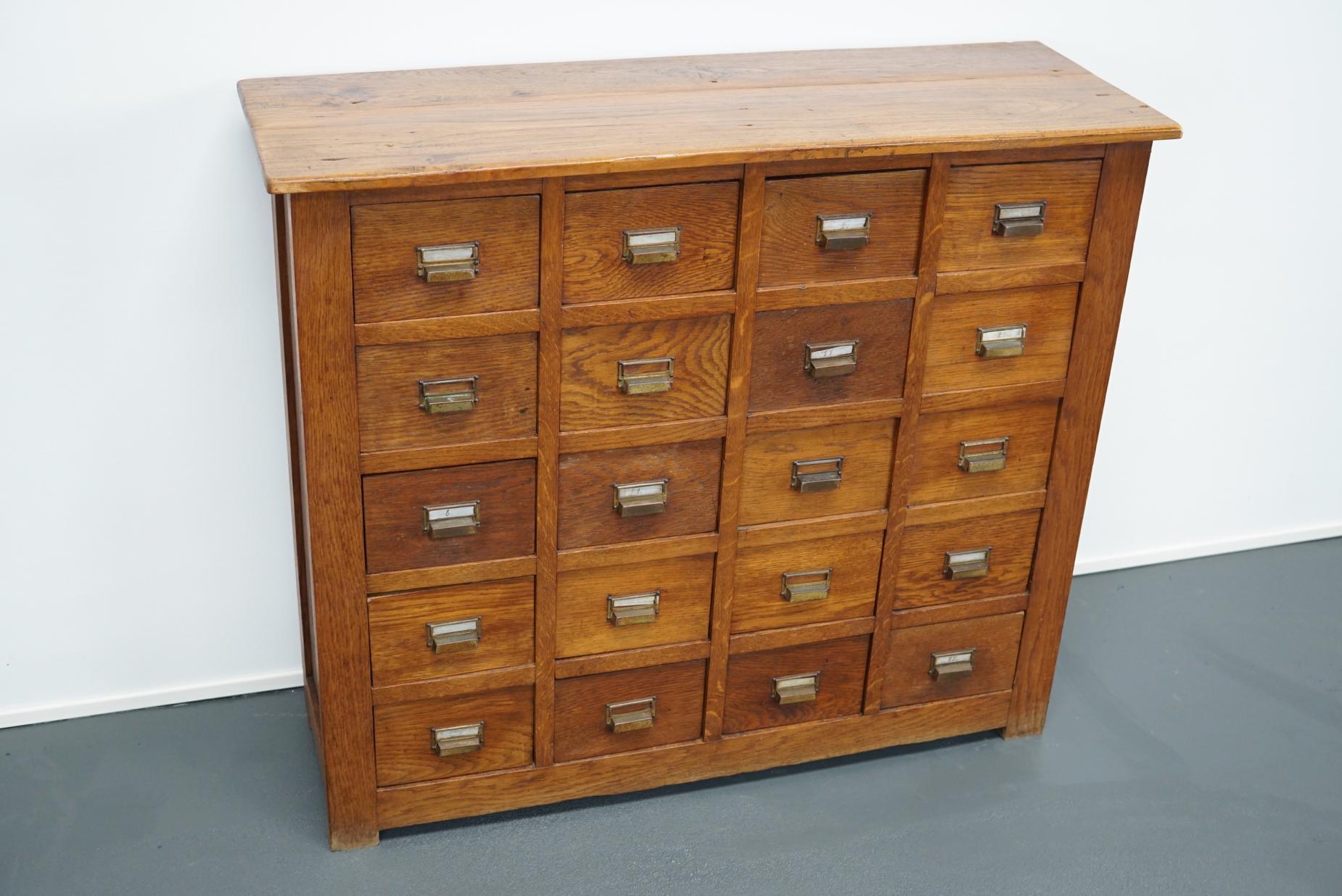 This apothecary cabinet with drawers was designed and made circa 1930 in France. The piece is made from oak and features 20 drawers with brass hardware. The inside drawer measurements are 24.2 x 15.7 x 10 cm.
 