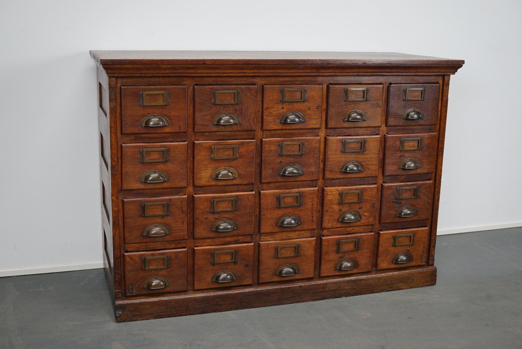 This apothecary / filing cabinet was produced during the 1930s in France. This piece features 20 drawers. The interior dimensions of the drawers are: D x W x H 35 x 16 x 11 cm.