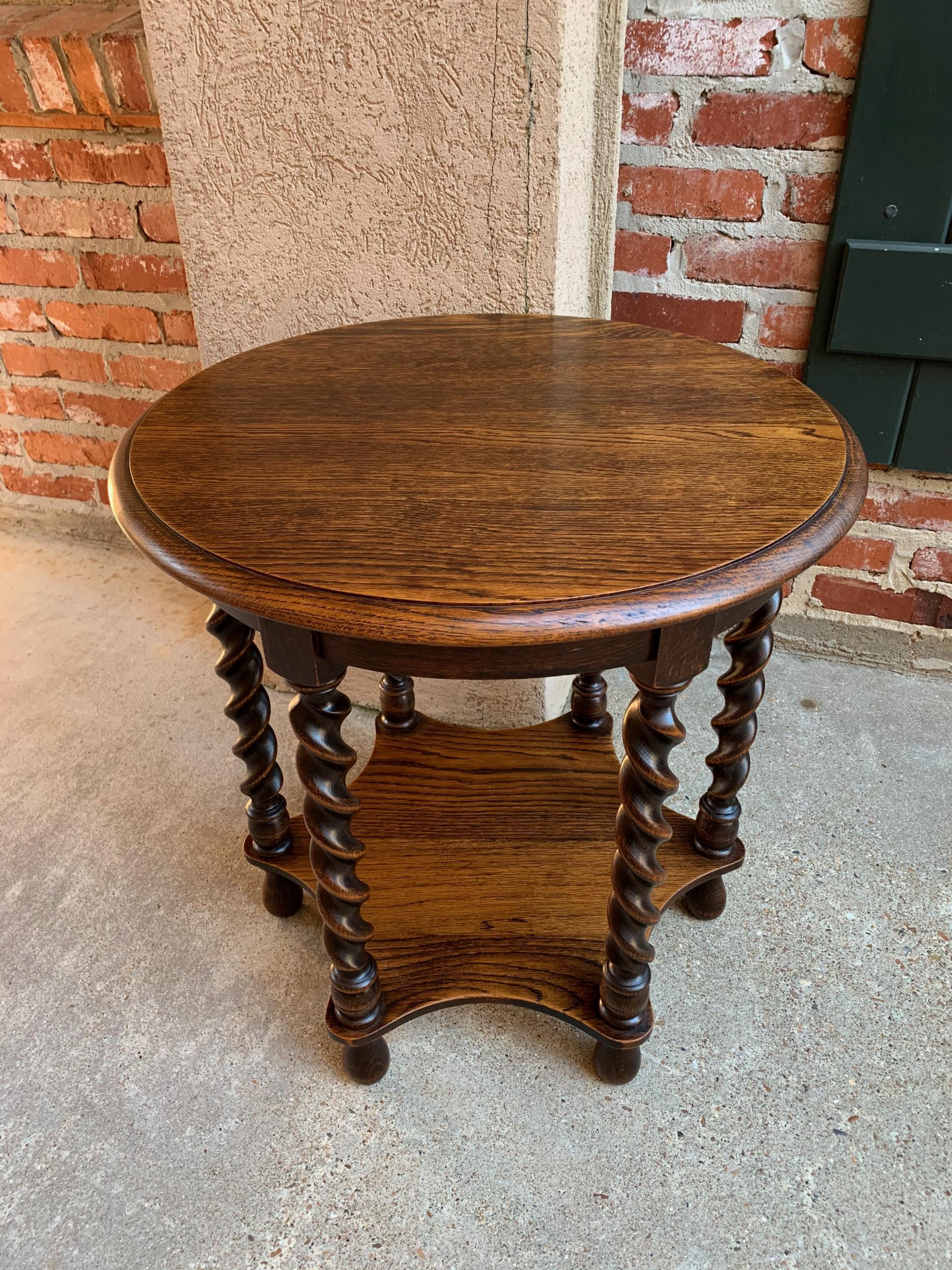 Vintage French oak barley twist round side table two-tier accent table

~Direct from France~
~Lovely antique/vintage French oak side table with six barley twist legs, beveled round top, and shaped lower shelf for additional display~
~Six large