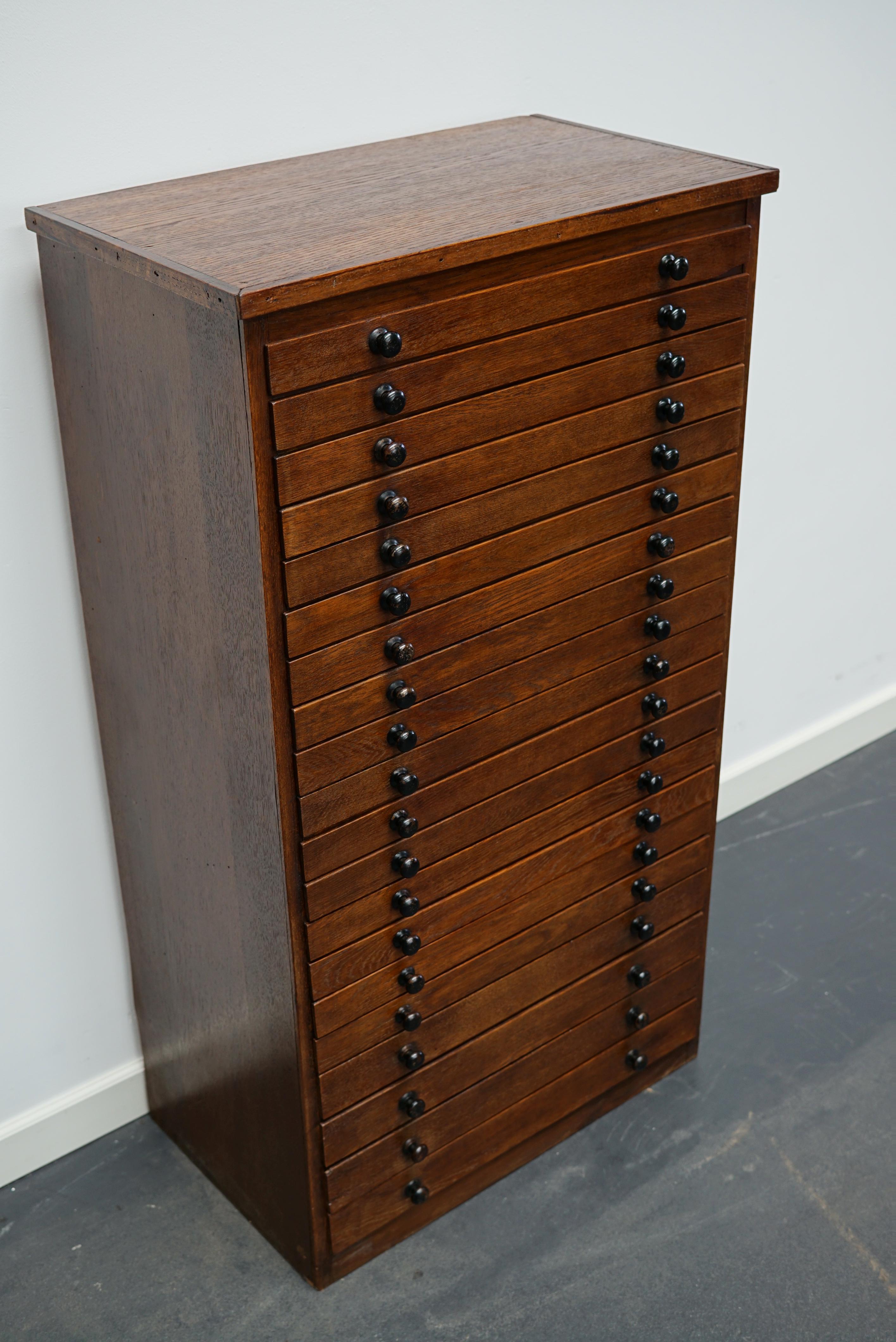 This jewelers / watchmakers cabinet was designed and made circa 1930/1940 in France. It features 20 oak fronted drawers in two different sizes: DWH 28 x 47 x 4 and 2.5 cm. It was used to store watch straps.