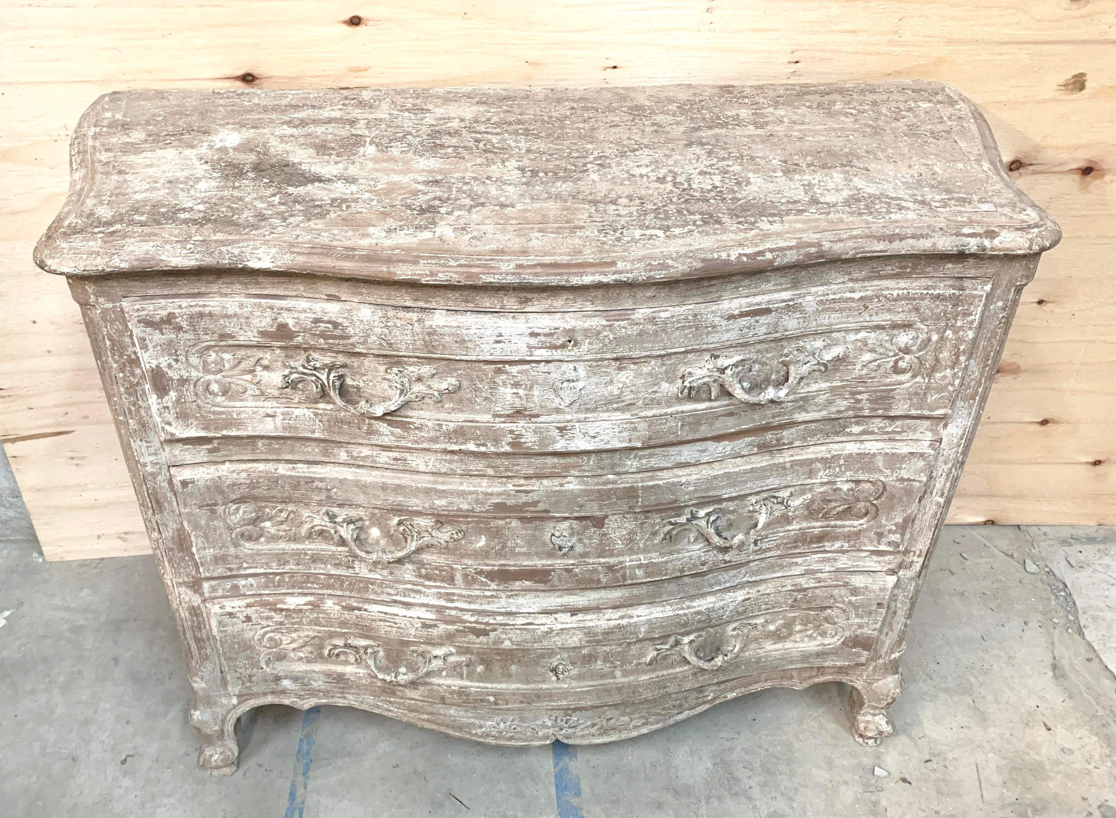 This chest features a serpentine front, cabriole legs and scroll feet. The Vintaged white finish is rubbed through and distressed to allow the natural beauty of the wood beneath to shine through. 

Acquired on a buying trip to France in 2019. 