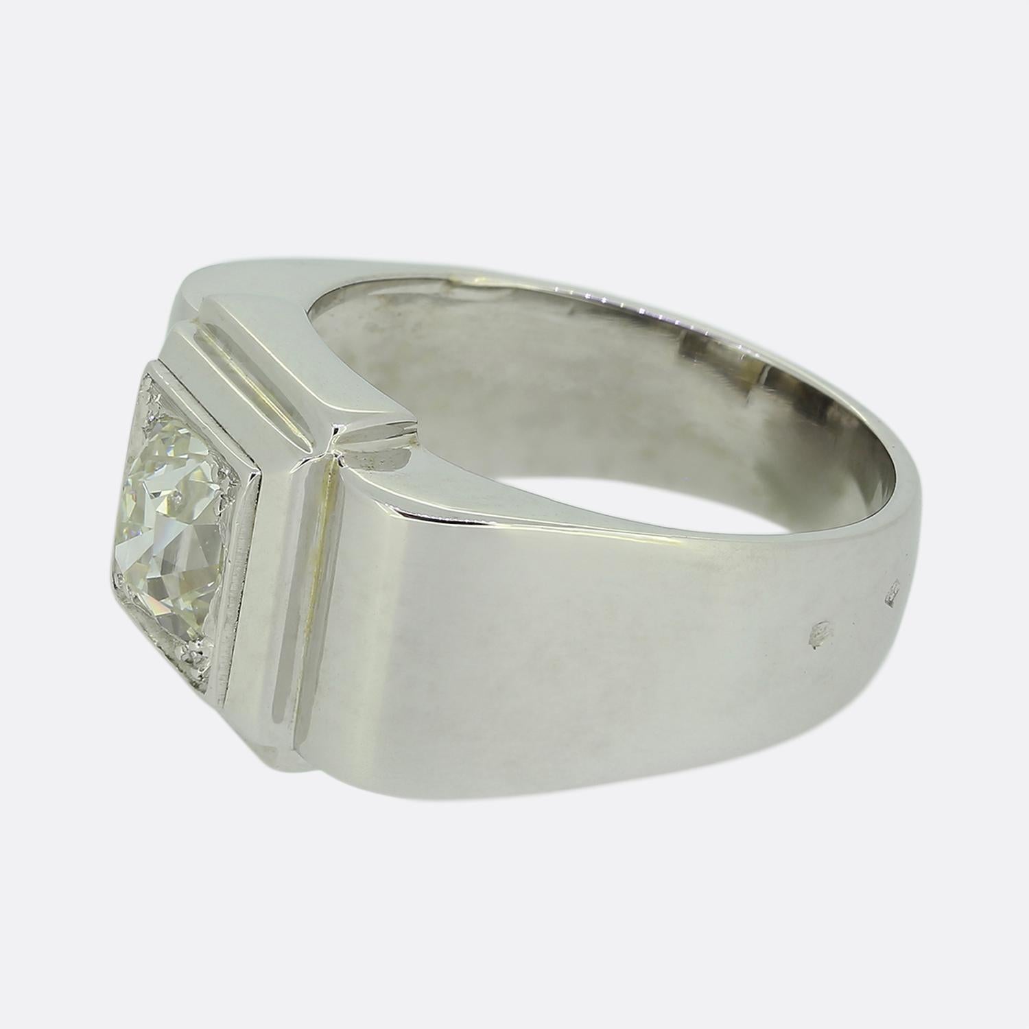 Here we have a marvellous diamond signet ring. Crafted in France from 18ct white gold, this vintage piece features a single 1.40ct old cushion cut diamond. This bright white imposing stone sits alone and proud at the centre of a multi-layered square