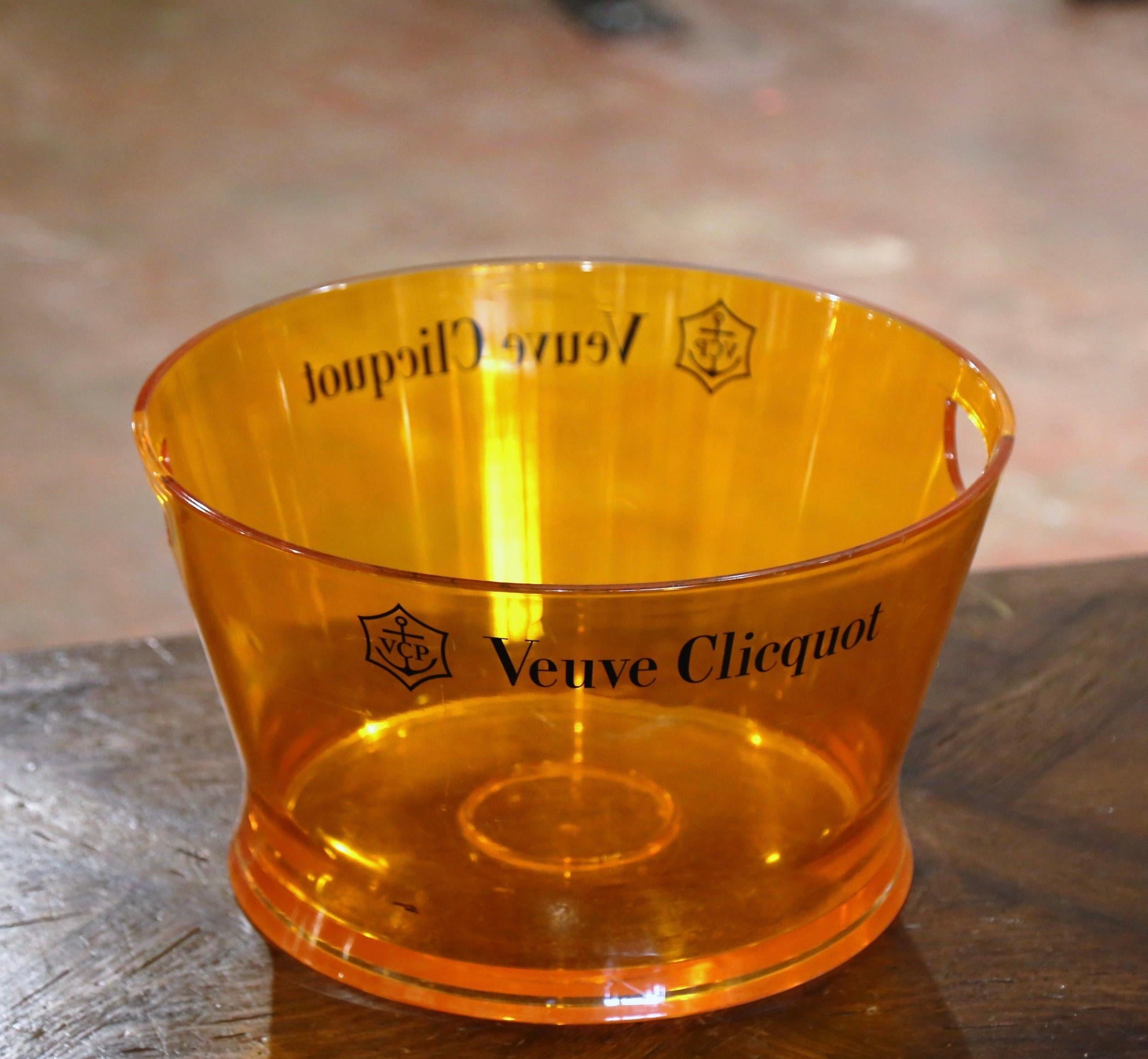 Decorate a wet bar or wine cellar with this elegant and rare champagne cooler. Crafted in France circa 1980 and made of hard plastic, the vintage bucket comes from the iconic House of Veuve Clicquot. The orange tub dressed with pierced side handles,