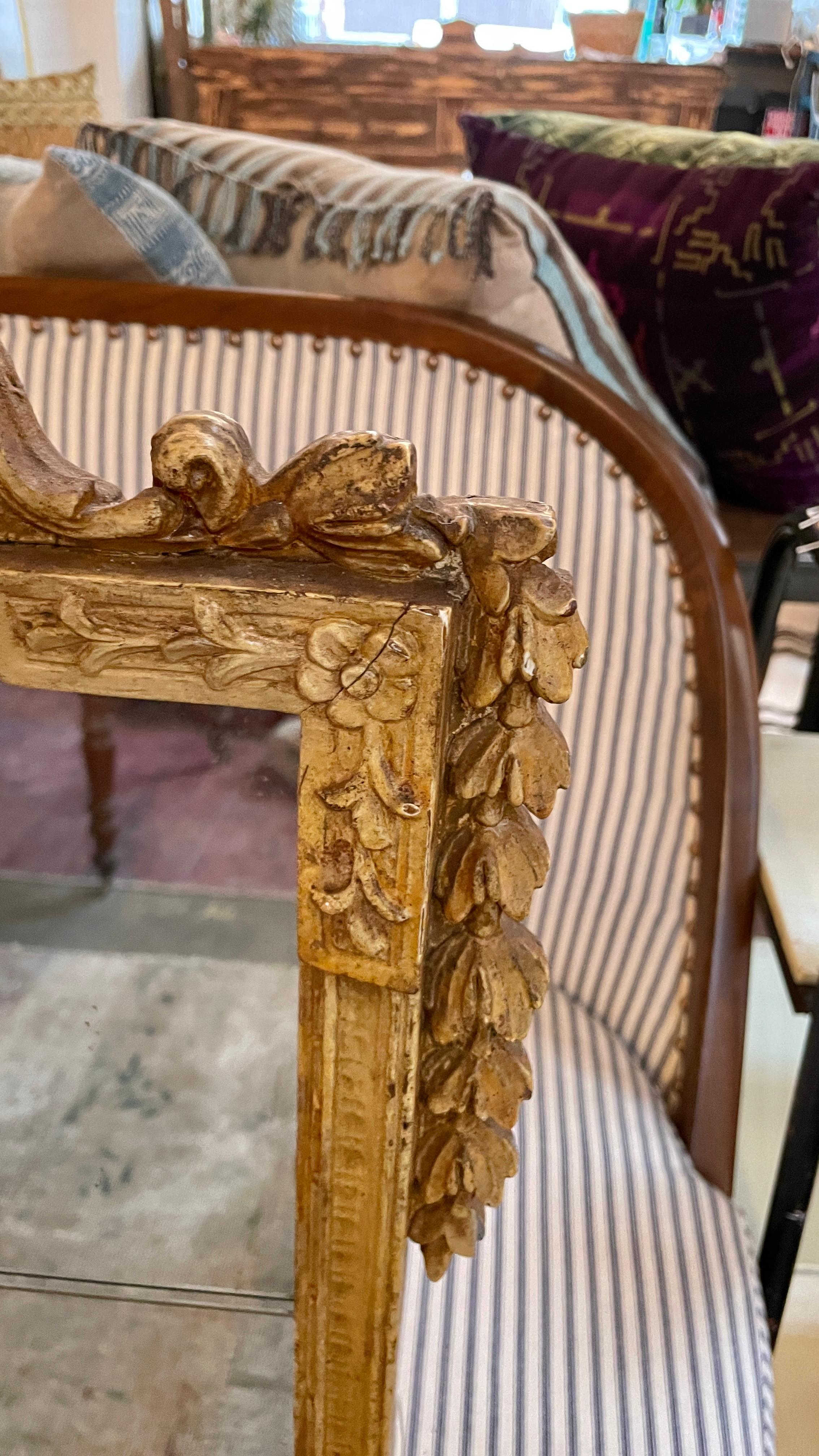 This beautiful antique ochre color painted large wall mirror is in great condition. The frame is painted with a beautiful warm golden yellow color around the ornate hand carved frame. Floral designs carved into the frame give this mirror an elegant