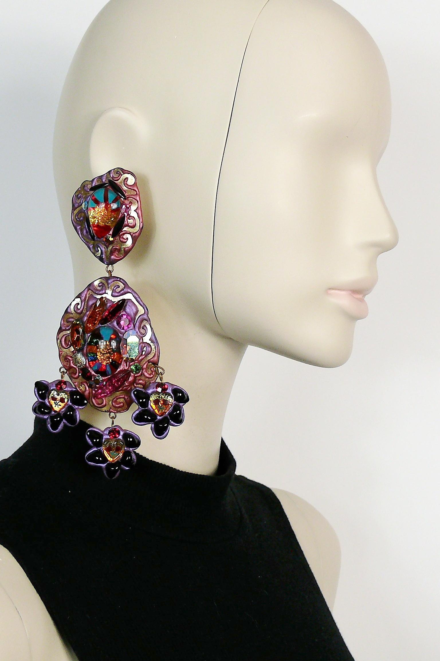 One-of-a-kind vintage French oversized dangling earrings.

These earrings are made of a light weight malleable material (probably rubber or latex) embellished with glass beads, crystals  and a gold tone embossed design.

The ex-owner has confirmed