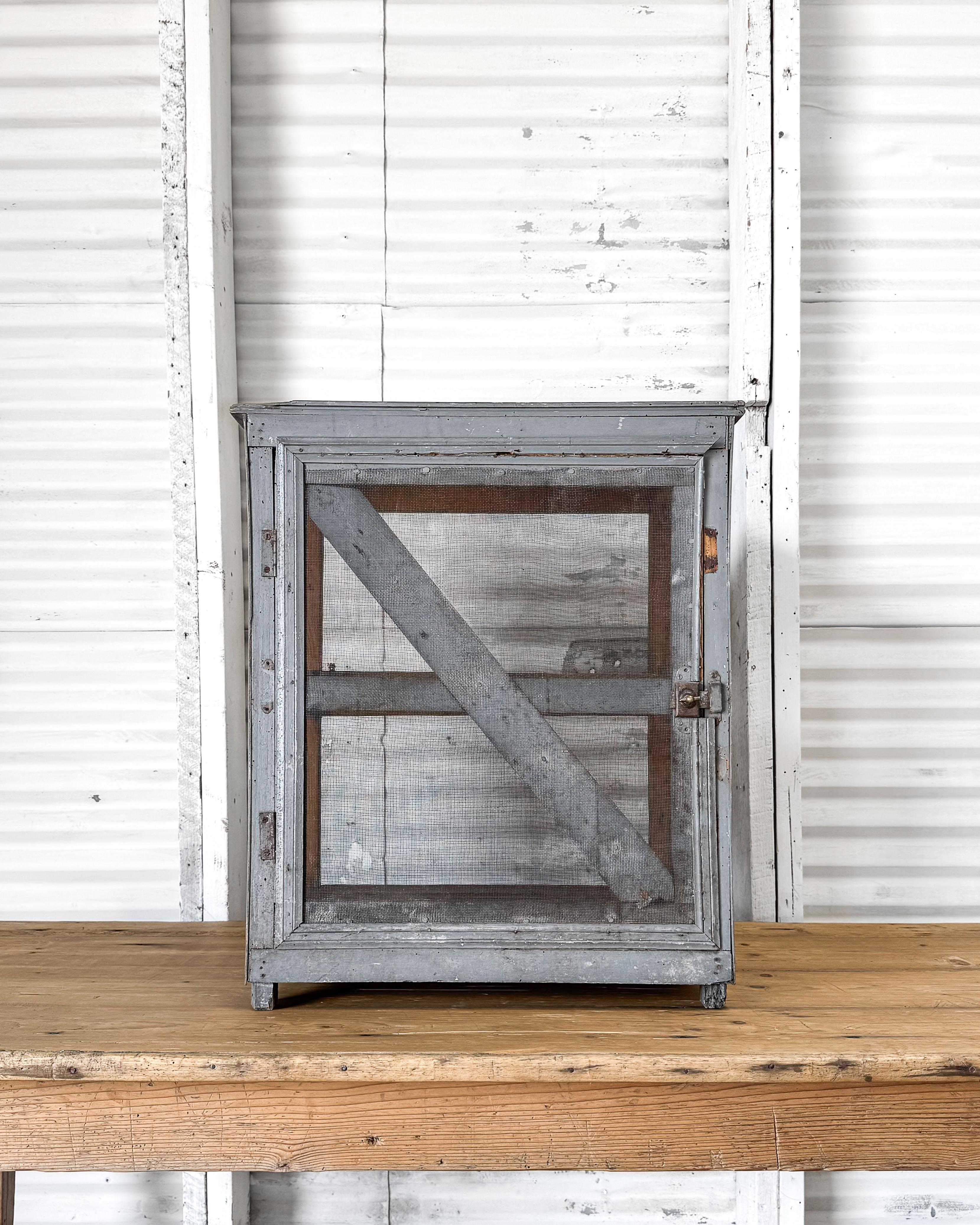 A small rustic vintage French food storage box, also known as a “garde-manger” or “fromagerie gardener,” this unique piece, featuring a single shelf and original old timeworn blue paint, was traditionally used in French country kitchens to age and