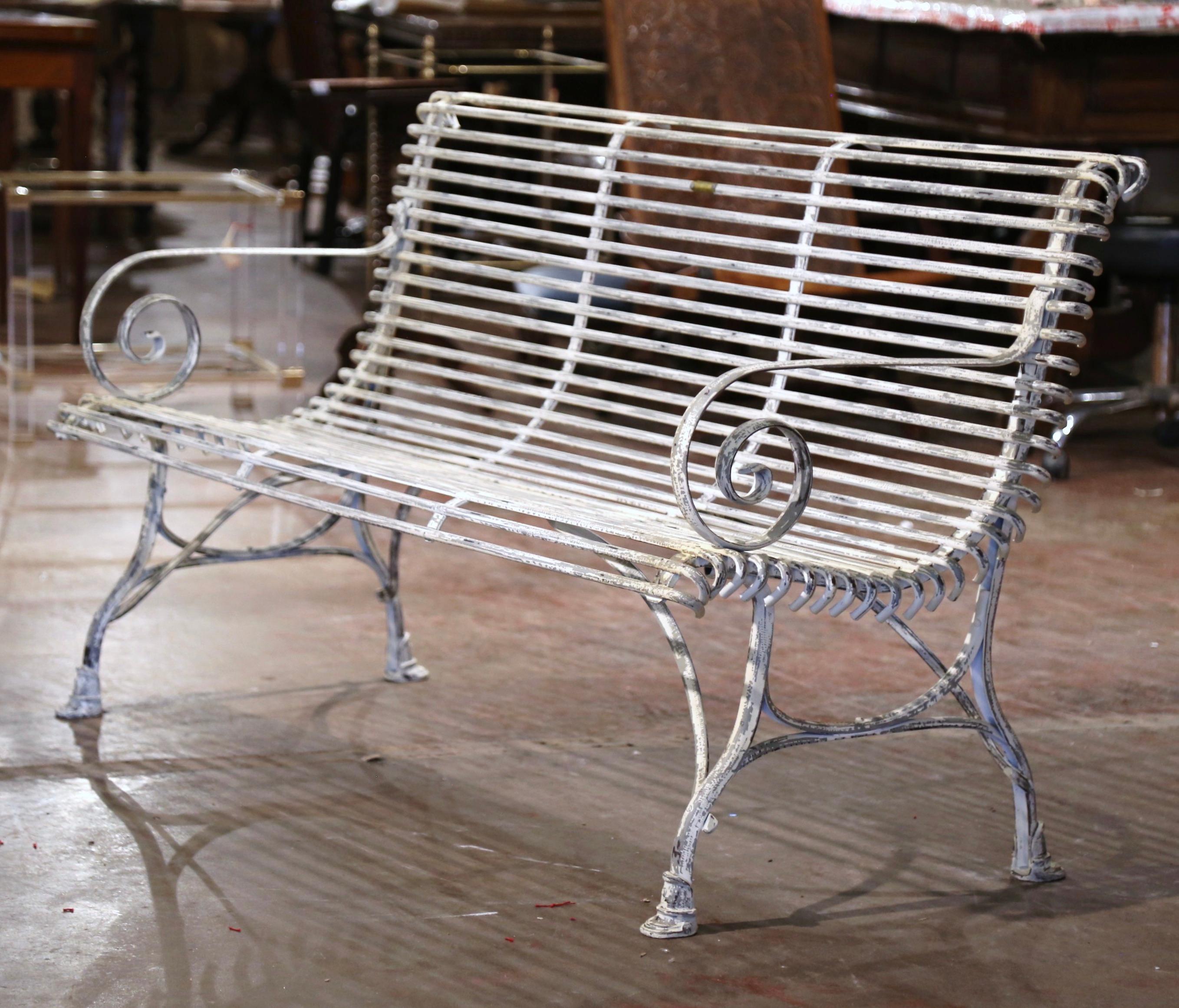 Add extra seating to a garden or outdoor space with this elegant forged iron bench from France. Complete with an antique patinated white and gray painted finish, the three-seat bench has gracious lines, beautifully scrolled armrests, a curved back