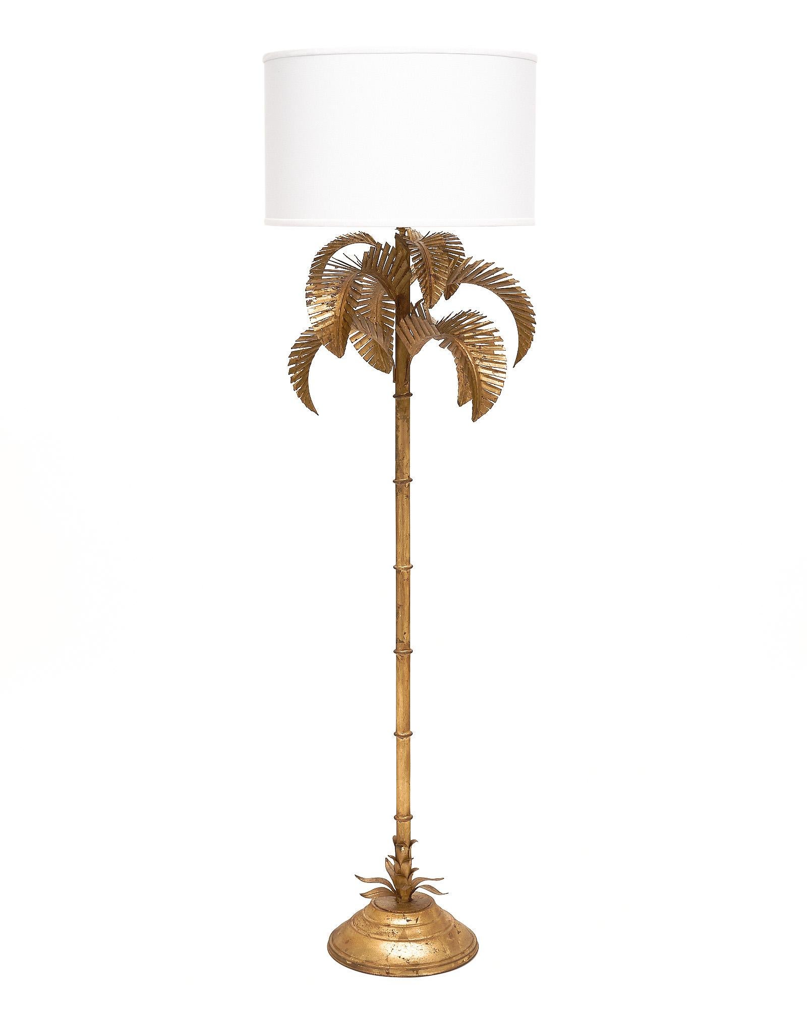 Vintage floor lamp finished with gold leaf in the form of a palm tree. It has been newly wired to fit US standards.
