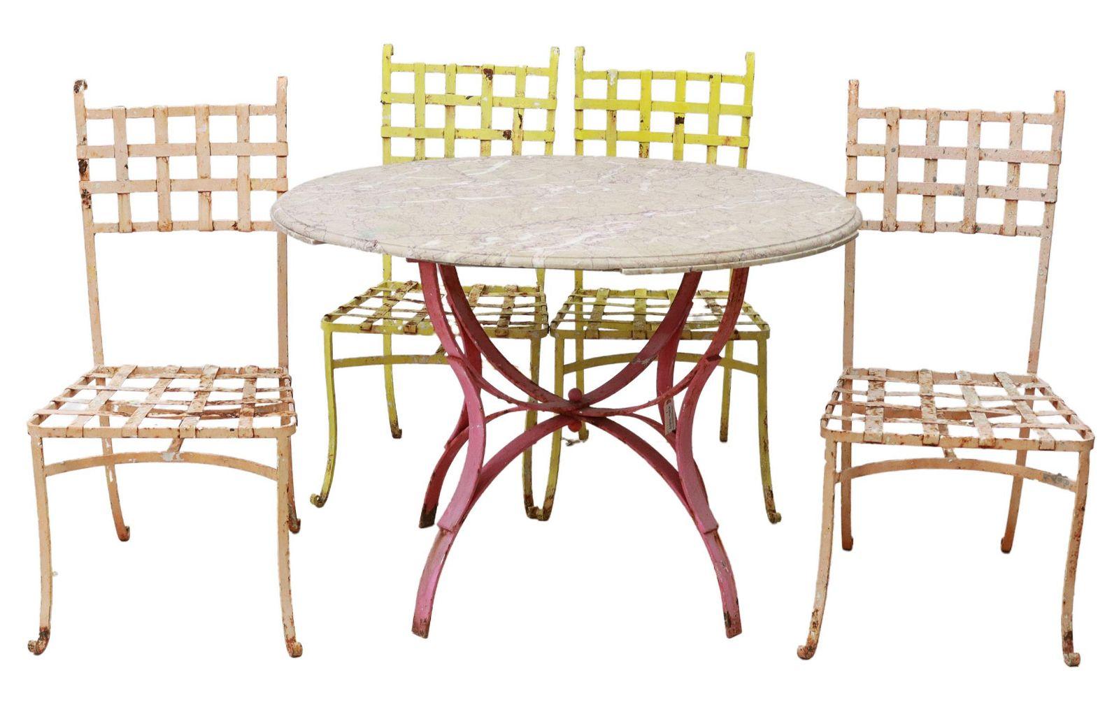 Vintage Bistro painted wrought iron patio set in original pink and yellow patina. This set includes a bistro table with a  round marble top, over pink painted iron base, rising on four curved legs, loss to the underside of the marble (this lower