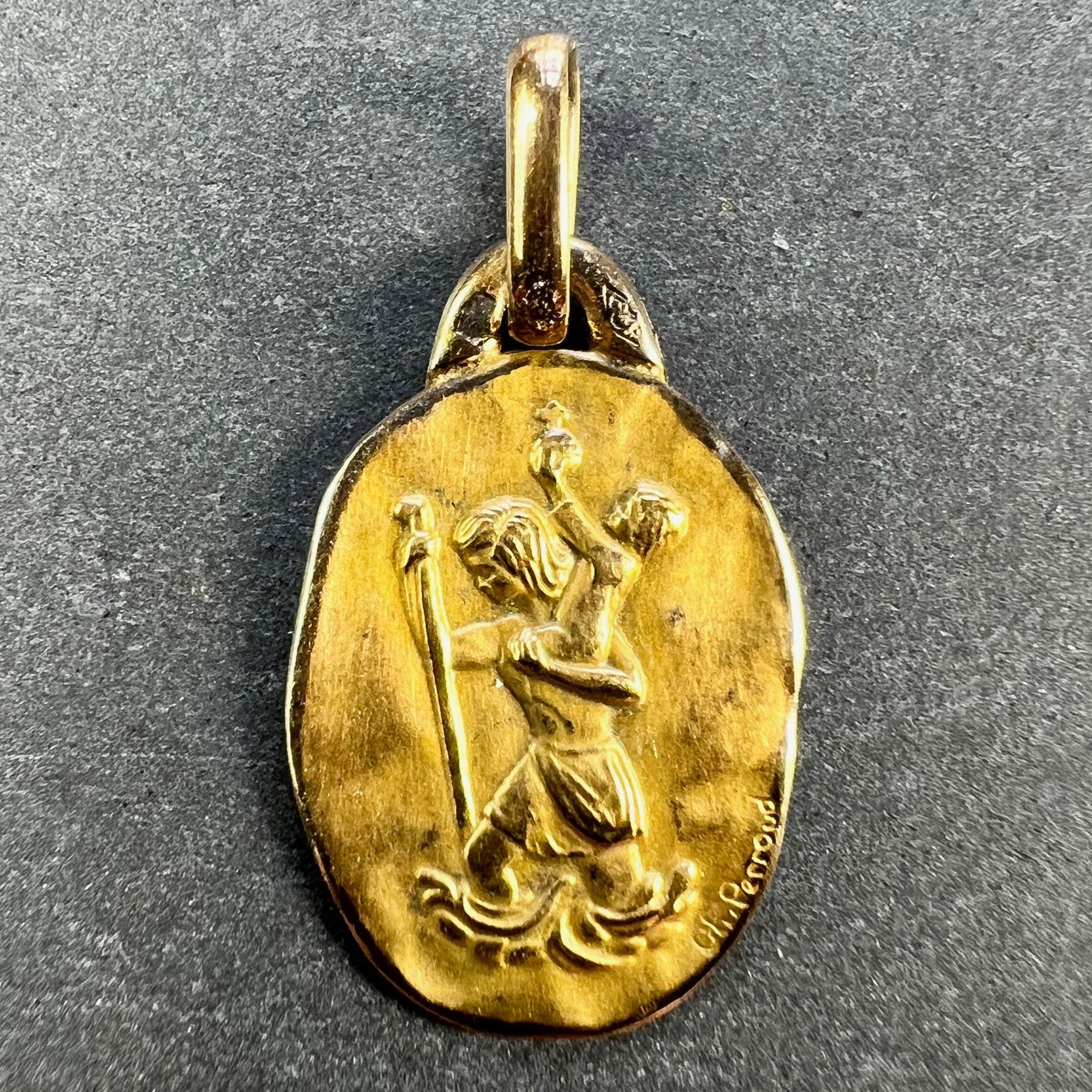 A French 18 karat (18K) yellow gold charm pendant or medal by Perroud depicting St Christopher carrying the infant Christ across the river. Stamped with the eagle's head for French manufacture and 18 karat gold, Perroud's makers mark, and signed Ch,