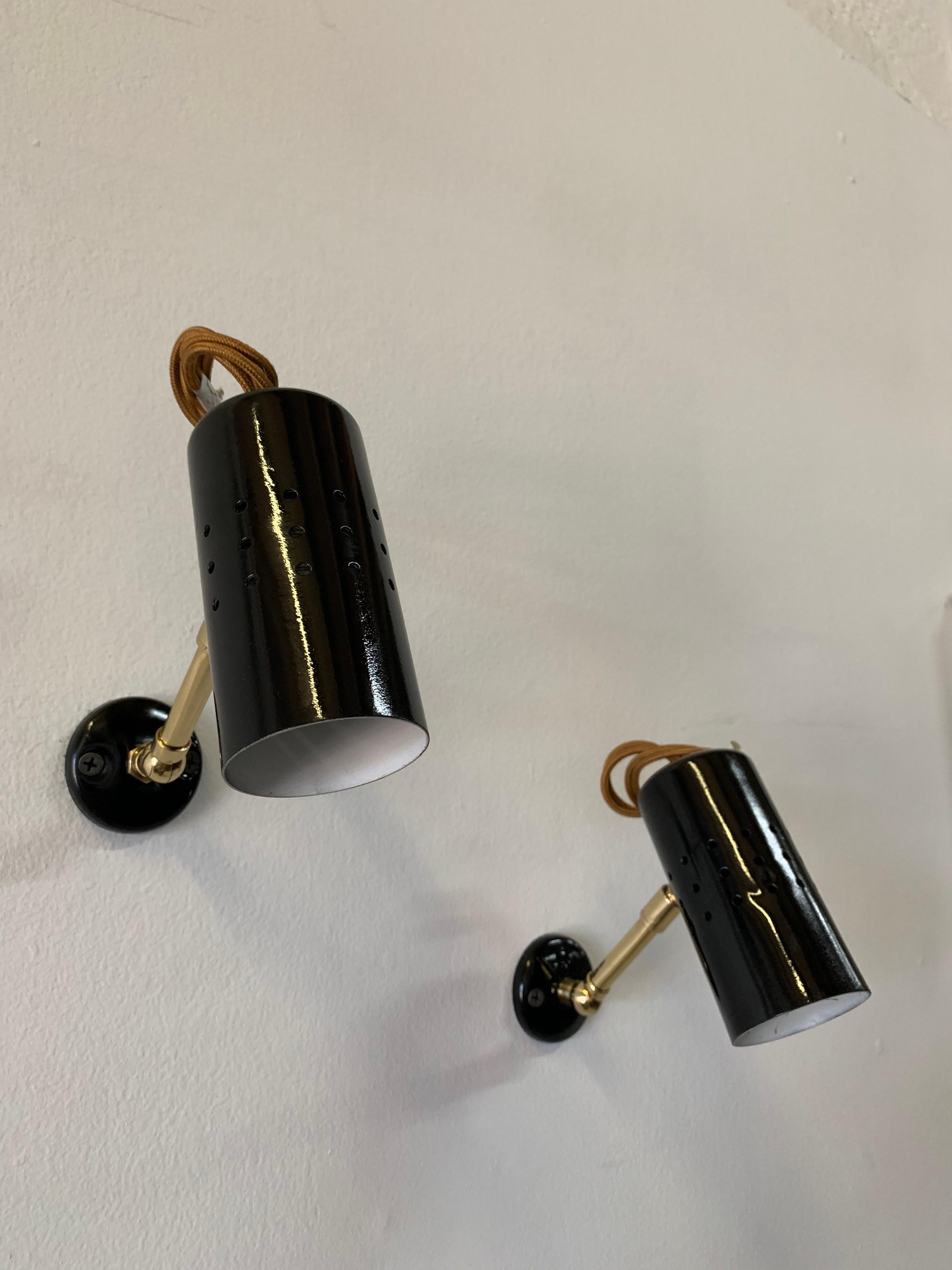 Attributed to Jacques Biny, these fully articulating petite spot lights with exterior silk wiring (see detail images). Very whimsical and perfect for library, art, shelves, etc.