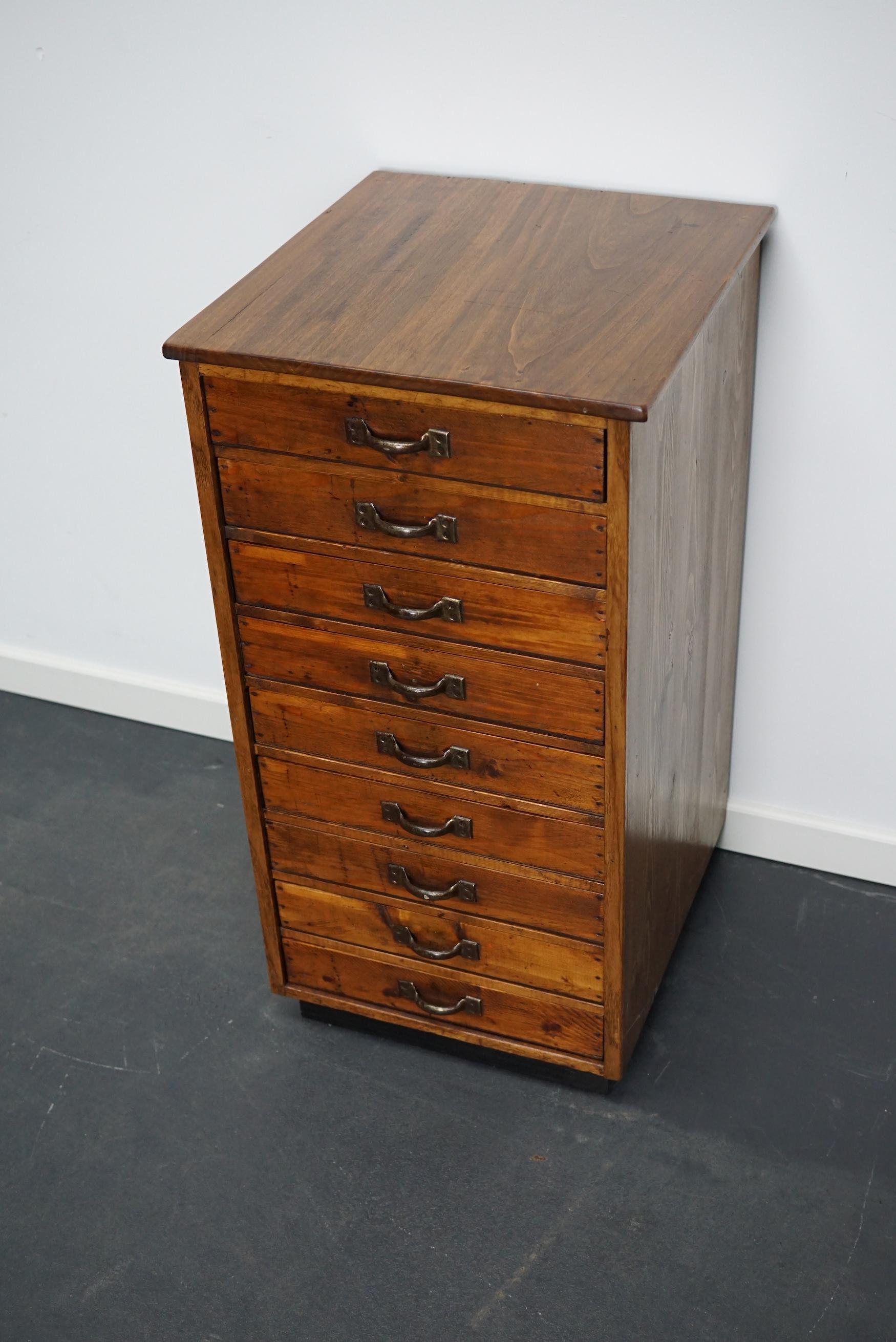 This apothecary cabinet was designed and made circa 1930/1940 in France. It features 9 pine fronted drawers with nice handles and a beech top. The interior dimensions of the drawers are: DWH 40 x 32 x 6 cm.