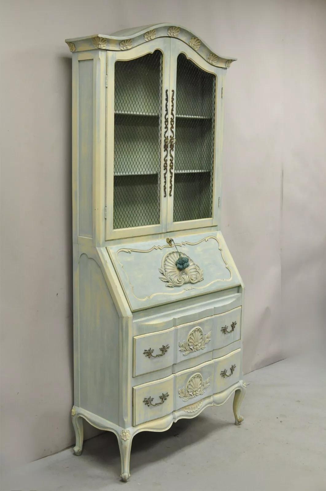 Vintage French Provincial Blue Distress Painted Bookcase Tall Secretary Desk by Danby. Item features shell carved accents, working lock and key, solid wood construction, great style and form. Circa Mid 20th Century. Measurements: 86