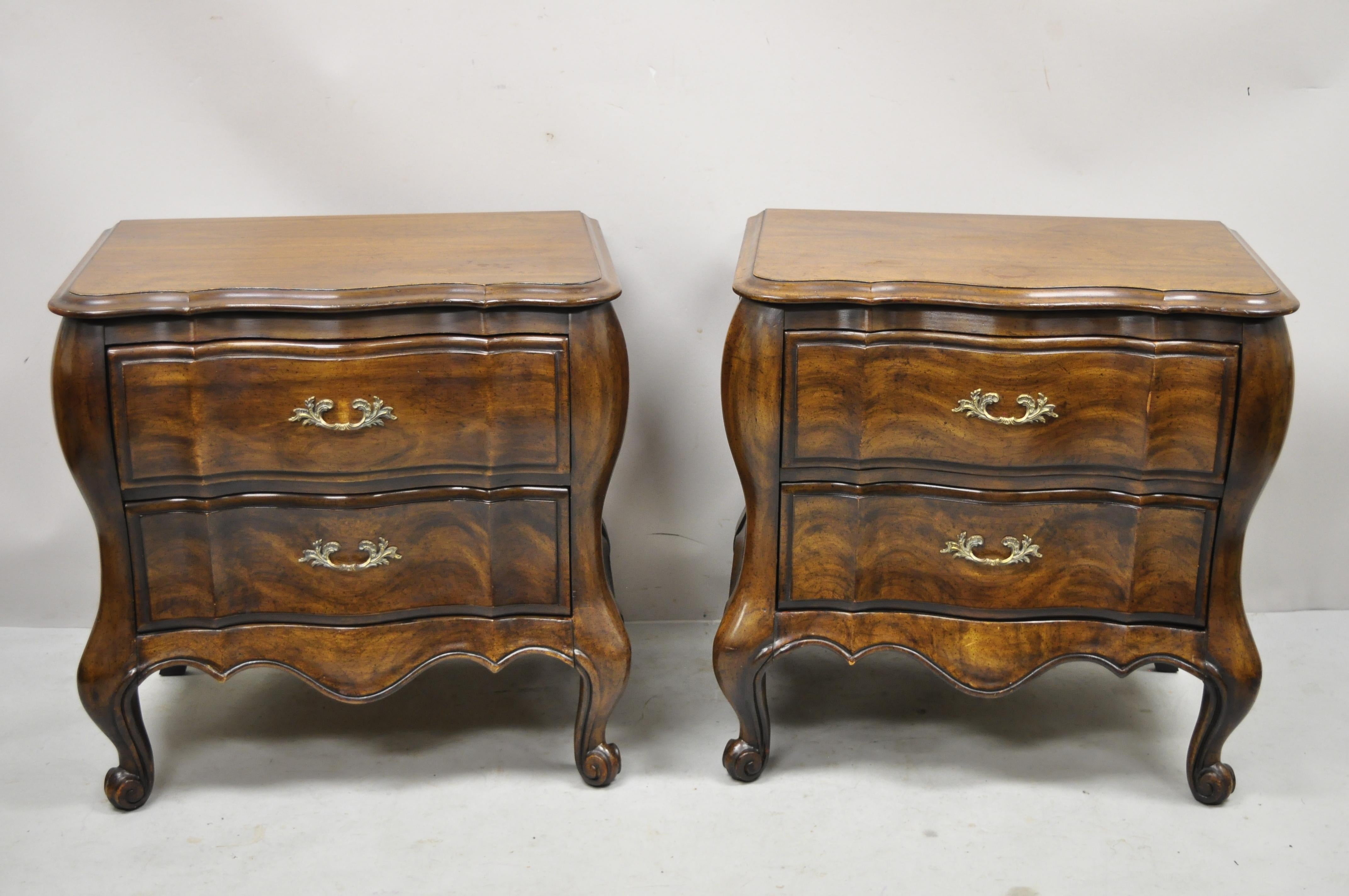 Vintage French provincial cherry wood bombe form nightstands by White Furniture - a Pair. Item features shapely bombe form, solid wood construction, beautiful wood grain, distressed finish, original stamp, 2 dovetailed drawers, cabriole legs, solid