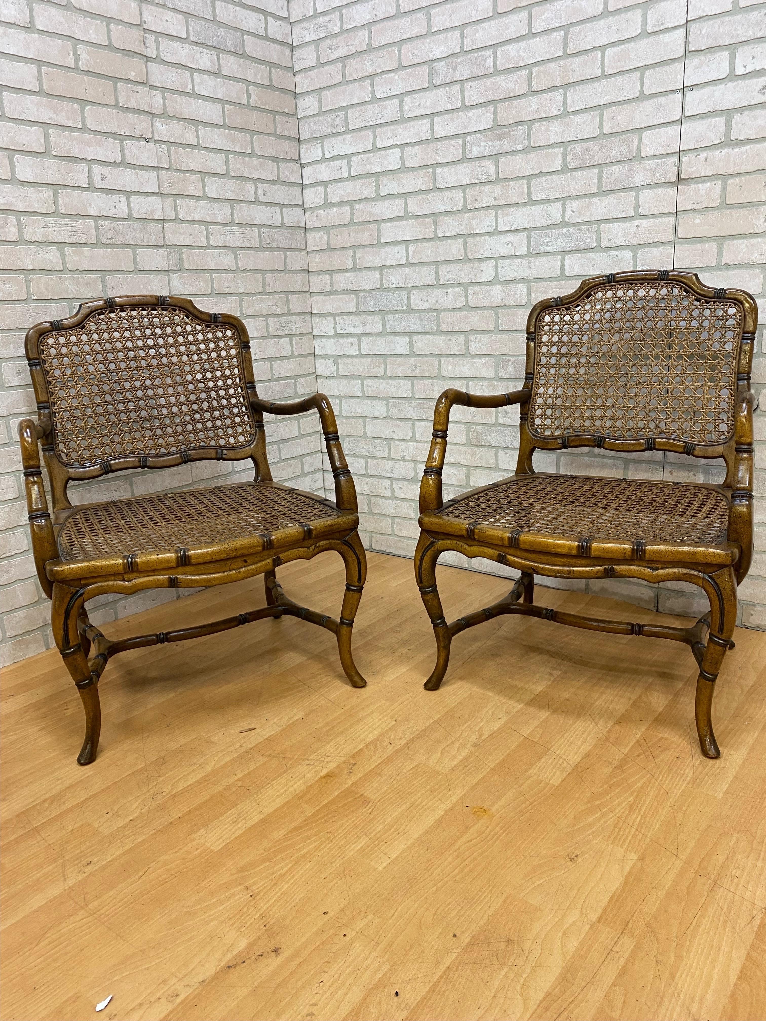 Vintage French Provincial Country Cane Faux Bamboo Wood Armchair - Pair 

Faux bamboo framed armchair with cabriole legs, cross and side stretchers and a caned back and seat. 

Contact us for custom seat pillows. 

Circa 1940

H 35
