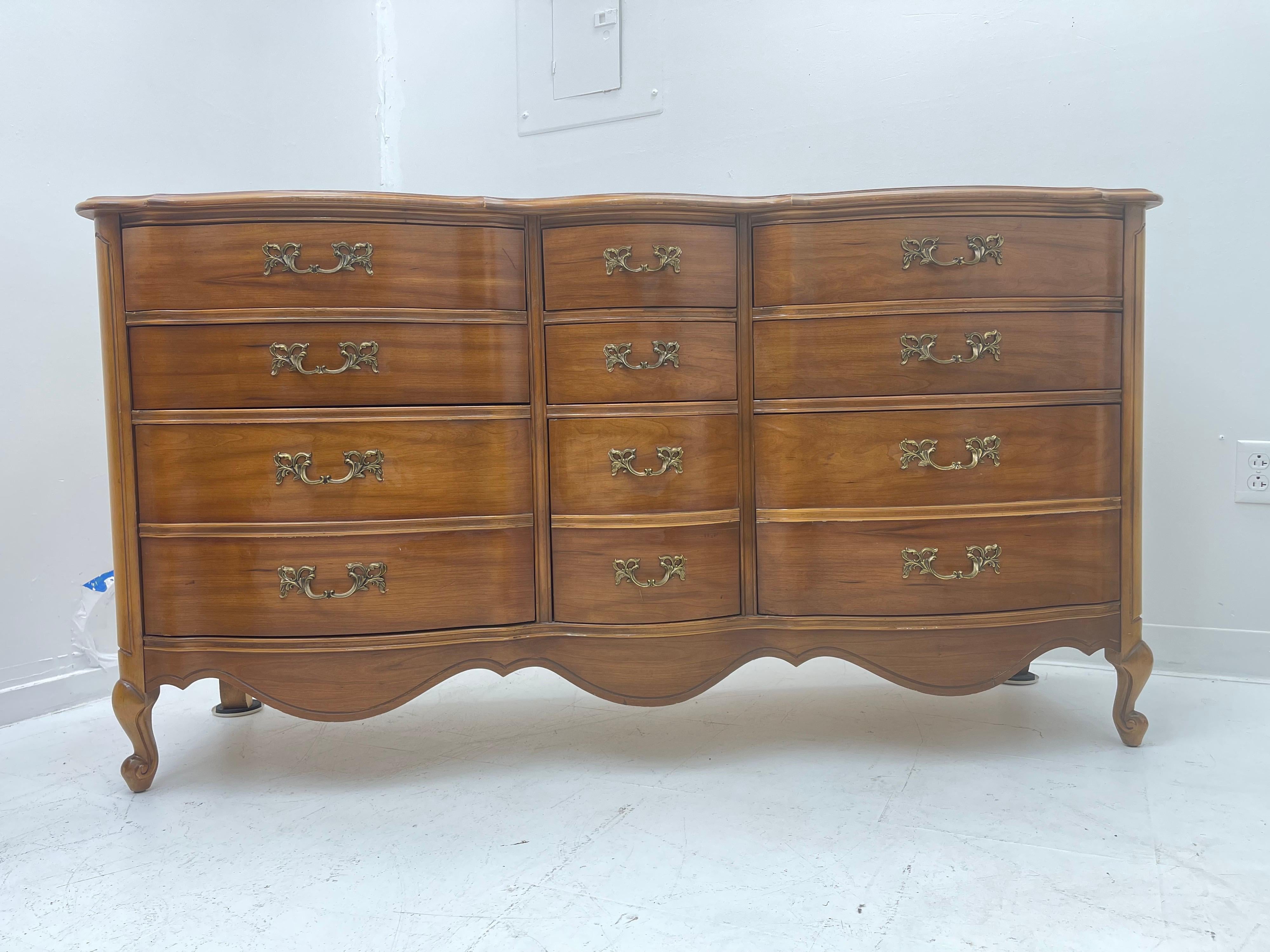 Vintage French Provincial dresser with 9 drawers that open smoothly.
Beautiful carved walnut triple dresser with original hardware and finish, Circa 1960’s. This piece has been well cared for and in excellent used condition.