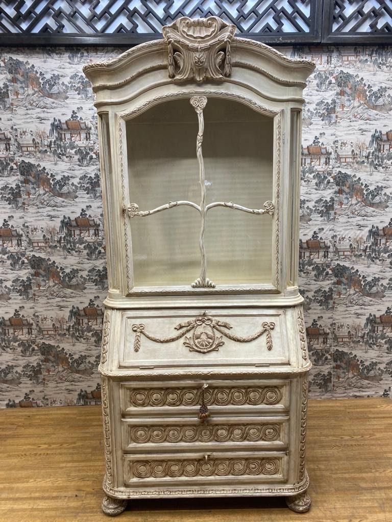 Vintage French Provincial Hand Carved White Secretary Desk and Display Cabinet 

This hand carved secretary desk has three drawers and a drop down desk. The top portion of this secretary desk can hold collectibles or double as a bookshelf.
