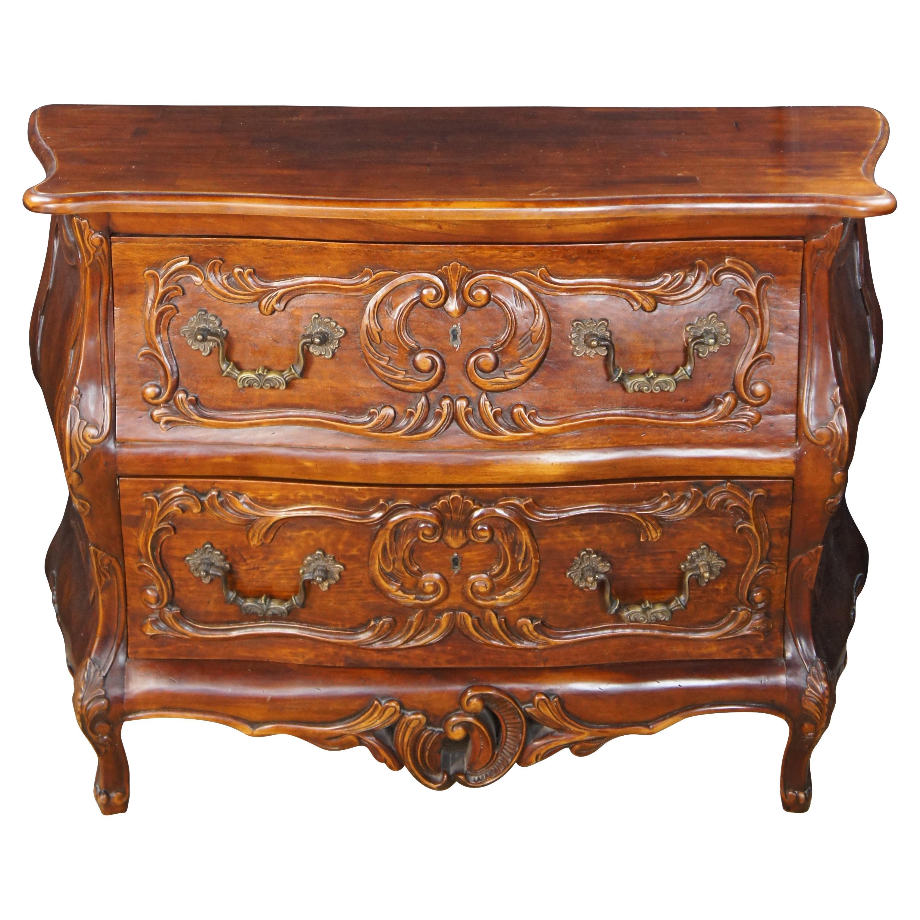 Vintage French Provincial / Louis XV style walnut bombe chest / commode / chest of drawers / console featuring a planked top with two large drawers and carved acanthus accents.

Dimensions:
47