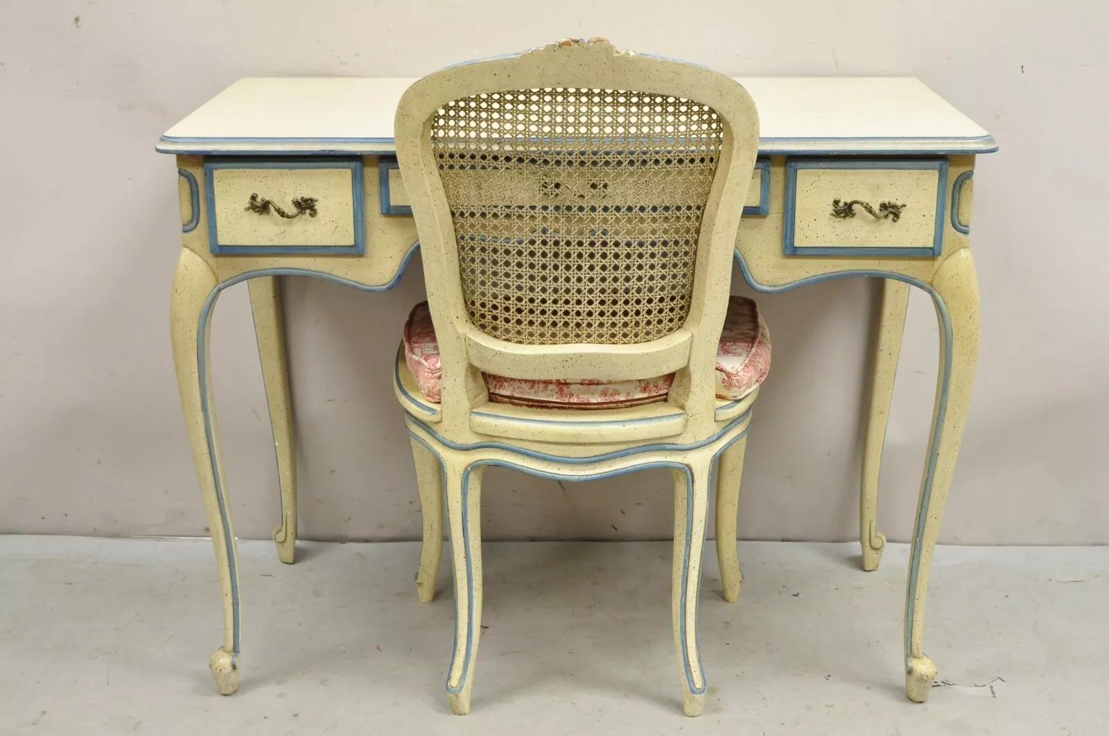 Vintage French Provincial Louis XV Style Cream & Blue Distress Painted Ladies Writing Desk and Chair Set. Listing includes a 3 drawer writing desk raised on cabriole legs and side chair with cane back and seat. Circa Mid 20th Century. Measurements: