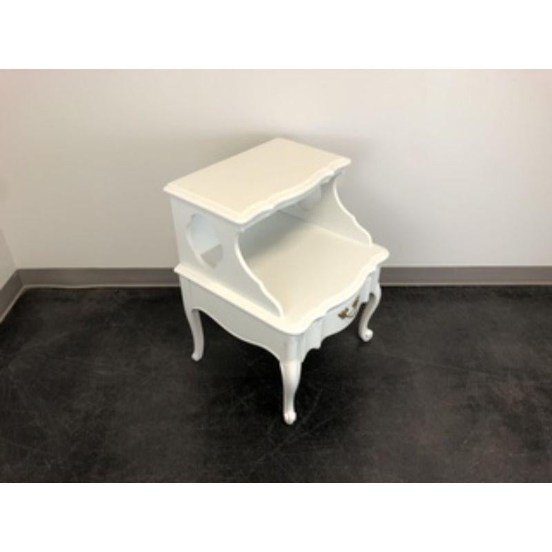 A French Provincial Louis XV style nightstand by Continental Furniture Company. Solid wood with step design and brass hardware. Features open shelf area and one drawer of dovetail construction. Made in High Point, North Carolina, USA, in the mid