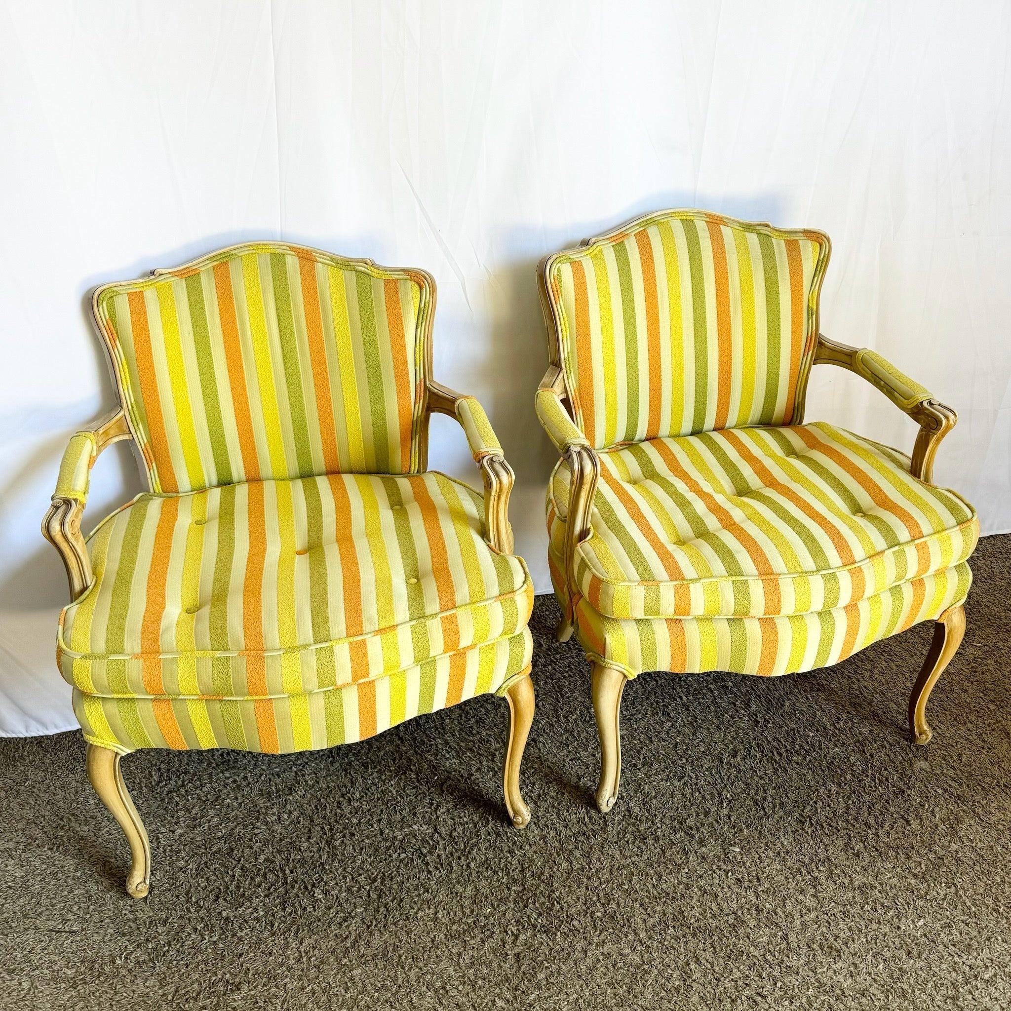 Pair of vintage French Provincial lounge chairs with carved wooden frames and vibrant orange, green, and yellow striped upholstery, adding sophistication.
 
 Minor marks to the fabric and legs as shown in the photos.
 
 We sell items as acquired,