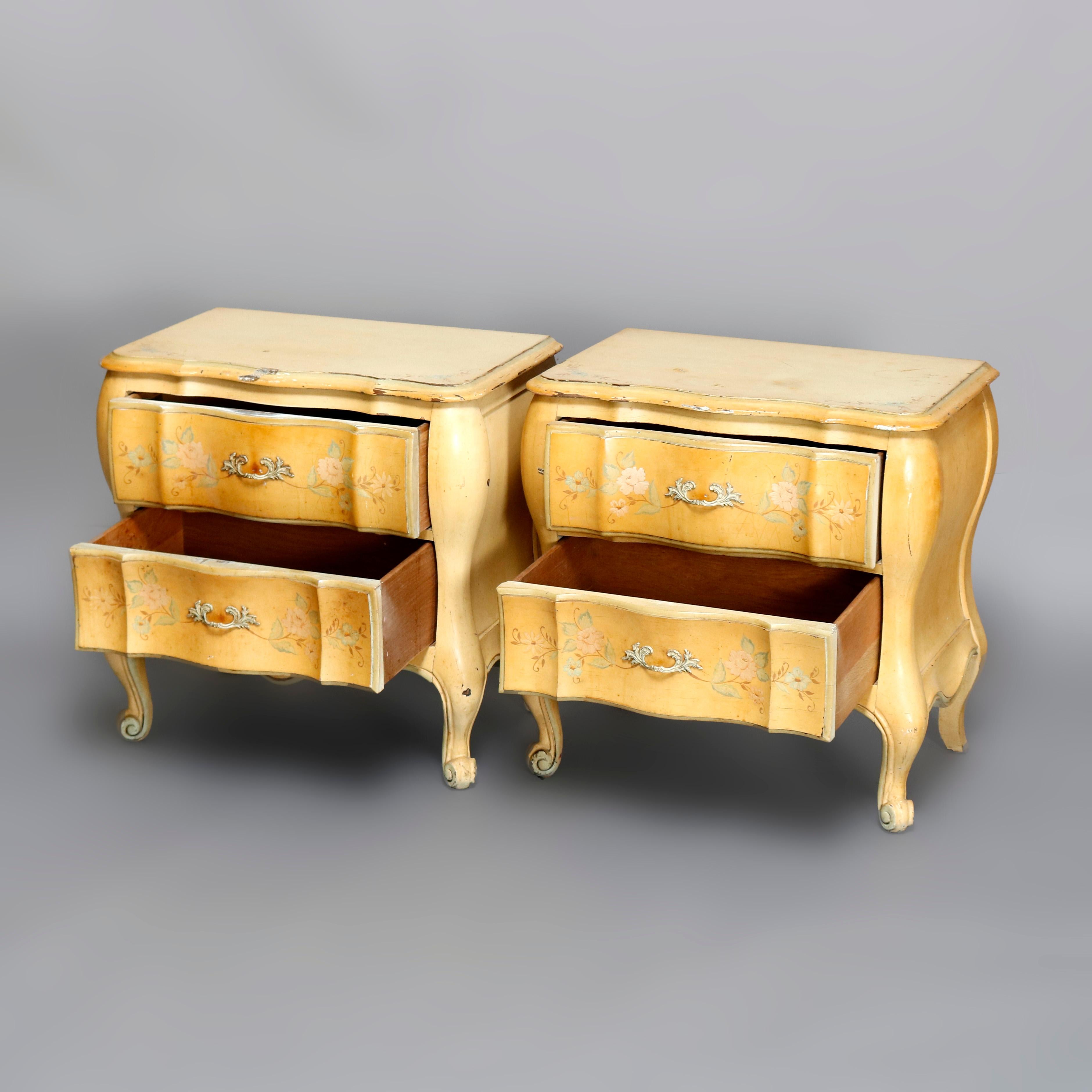 A vintage pair of French Provincial style bombe end stands by White offer shaped top over double drawer case, raised on cabriole legs terminating in scroll form feet, paint decorated with floral motif, maker label in drawer as photographed, 20th