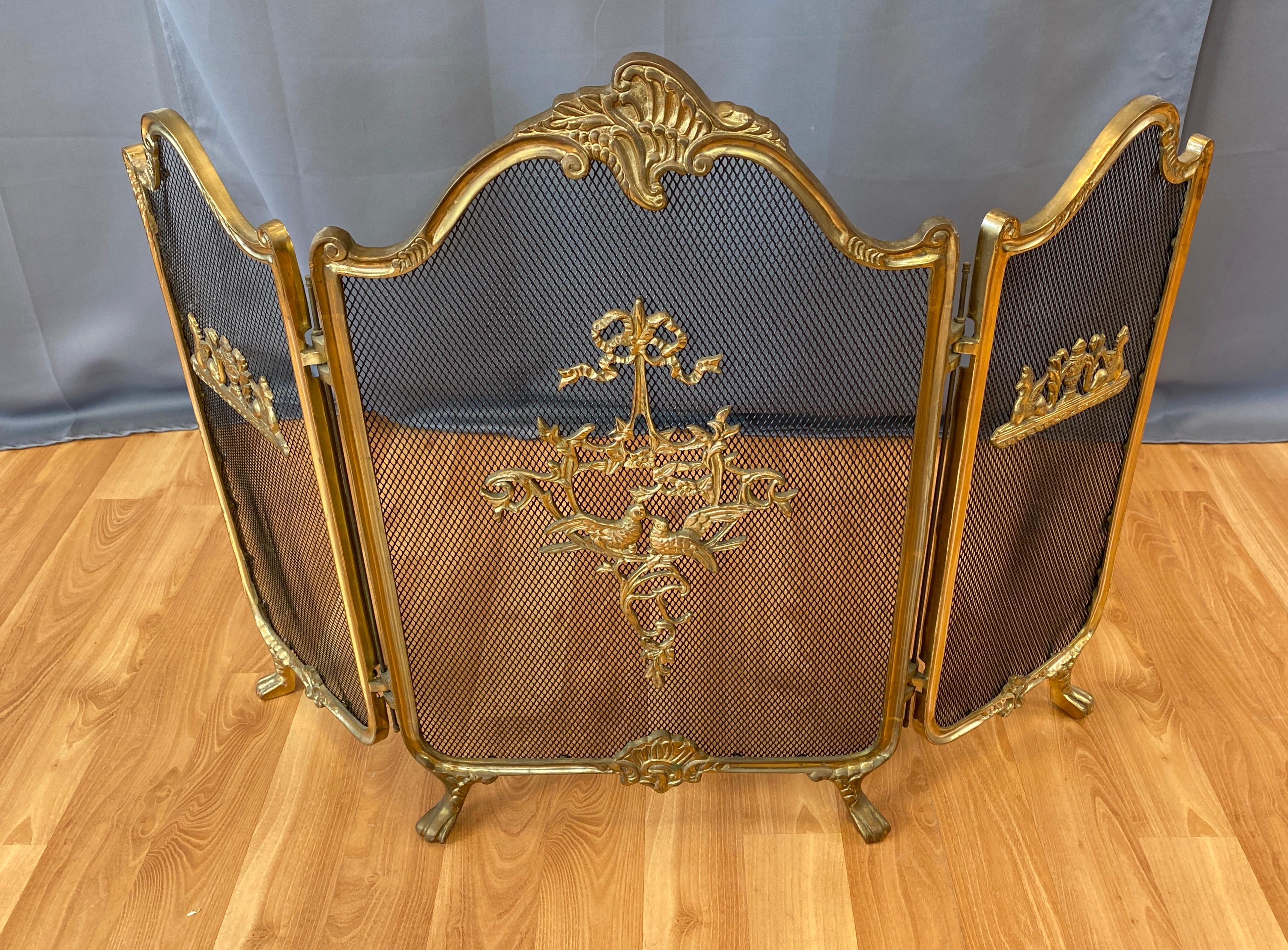 Vintage French Provincial style brass folding fireplace screen.
Large middle screen, with a smaller one on each side of, heavy brass casting design 
just about in the middle of each screen.

Measures: Large middle screen 18 x 28 3/4 high
Side