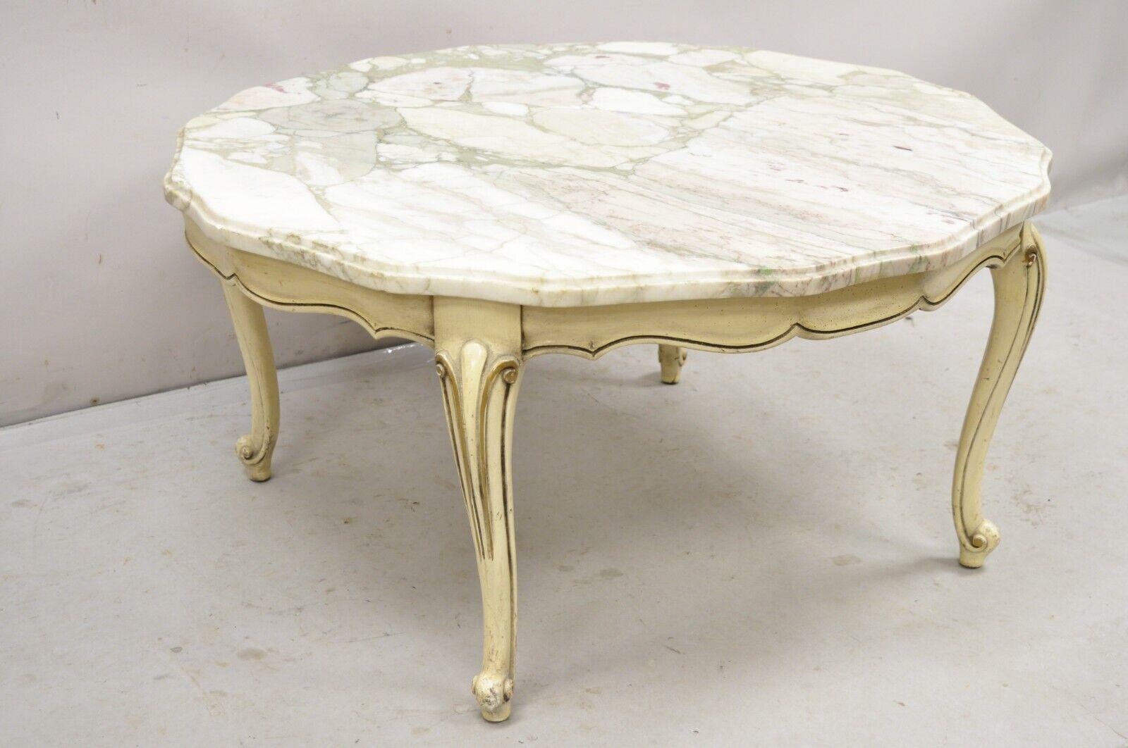 Vintage French Provincial Style Shaped Marble Top Cream Painted Round Coffee Table with Gray and Purple Veins. Circa 1960s. Measurements: 18