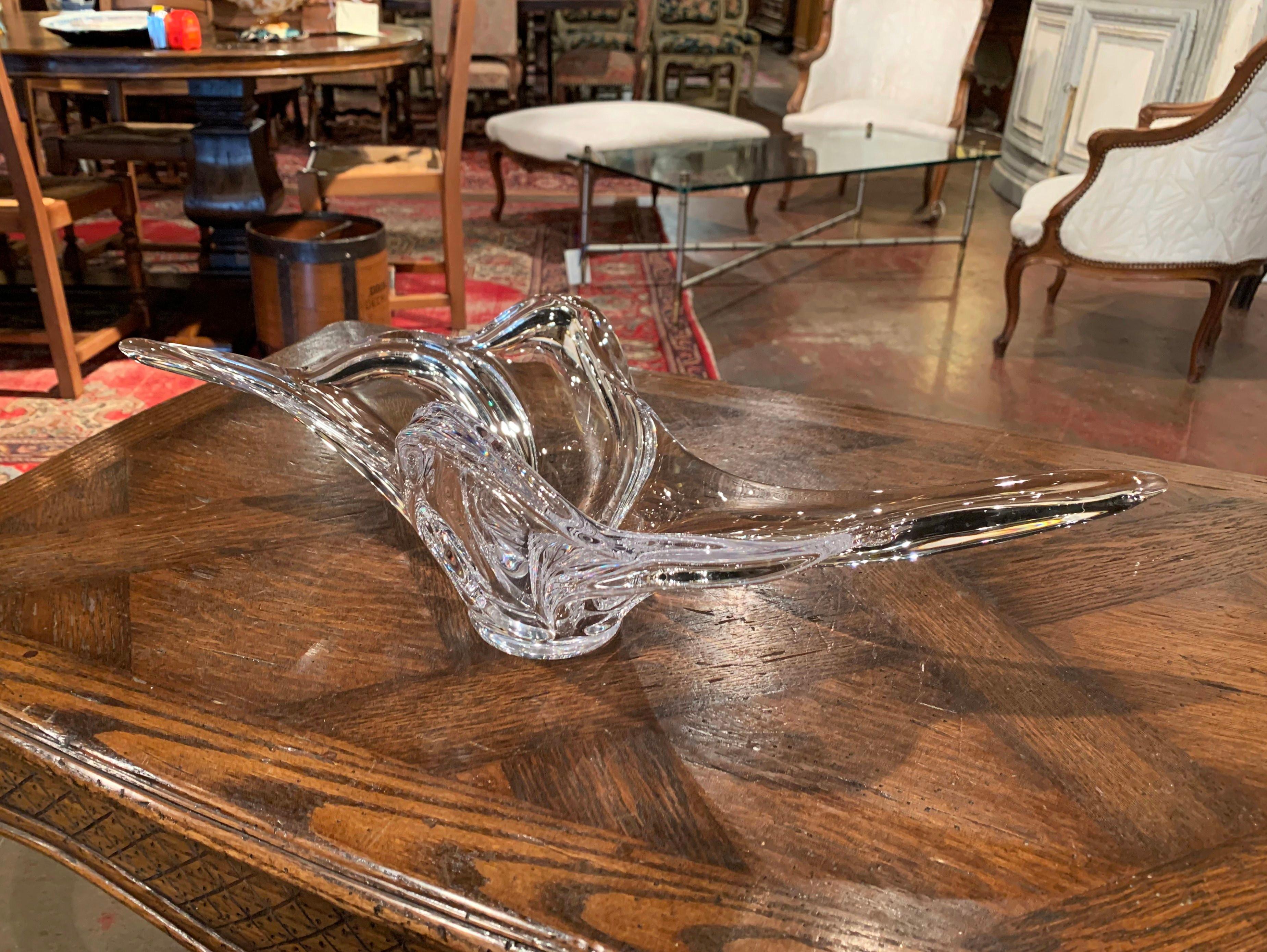 This elegant, hand blown crystal art glass console bowl was crafted in Vannes-le-Chatel, France, circa 1950. The large antique piece features a pulled feathered technique with an intricate elongated design. The elegant decorative centerpiece is in