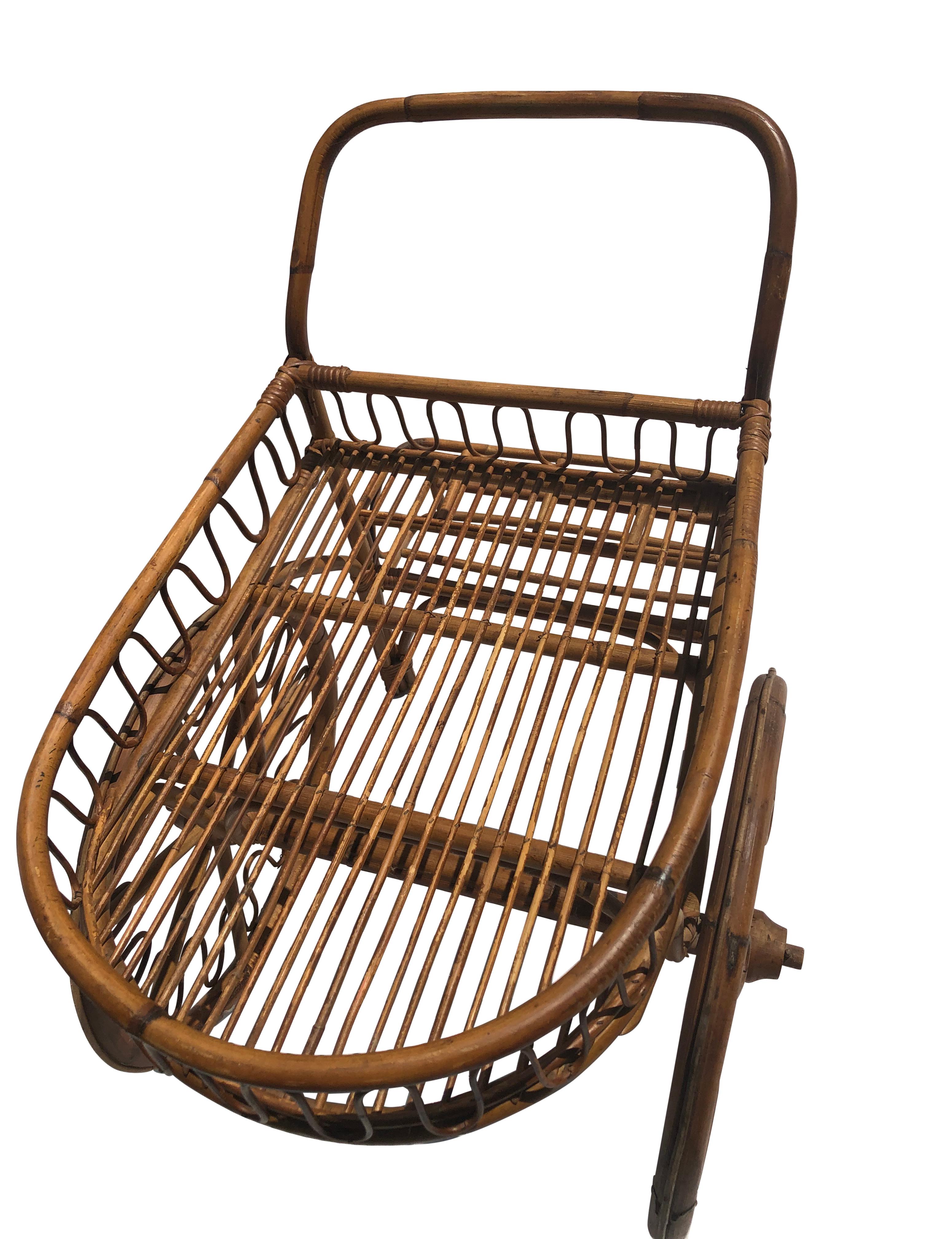 Vintage French Rattan Bar Cart. Designed to accommodate bottles and barware, its thoughtfully crafted construction marries utility with elegance and design. The whimsical touch comes courtesy of its oversized wheels, enabling effortless