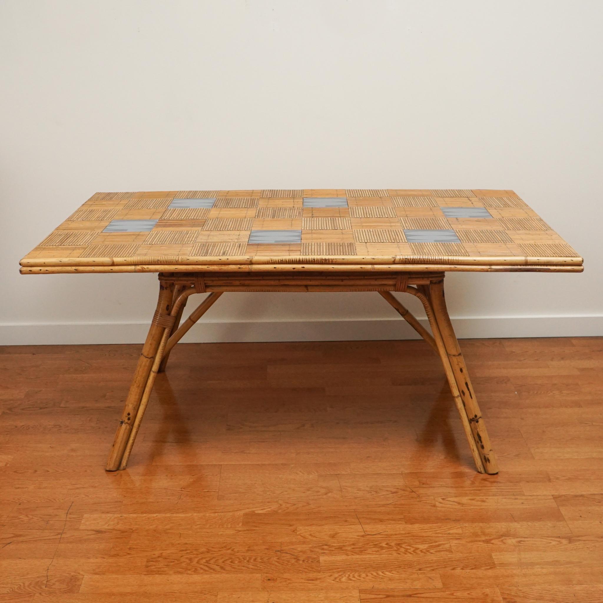 From the 1960s, this French rattan, tile-top dining table is certain to make an impression and/or set a mood. The table has been been gently restored and updated with modern ceramic tile insets. Sturdy and generously sized.