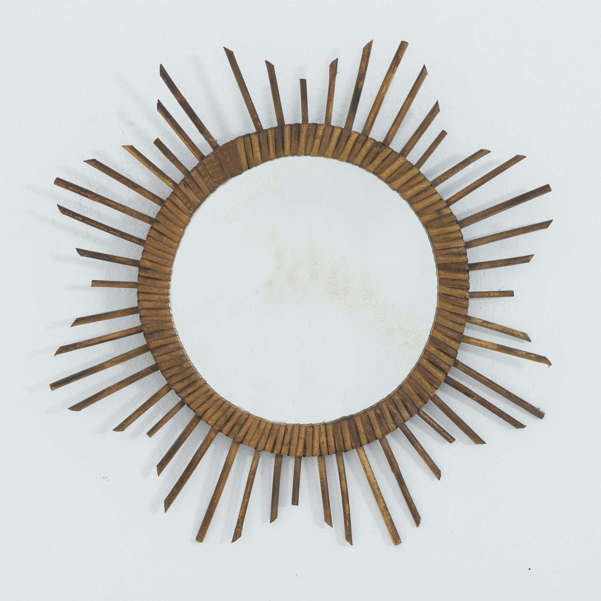 A retro throwback, this French 1970s mirror has a prominent circular shape, rendered in pleasant warm rattan. Surviving the unforgettable epoch of 70s fashion, this woven beauty is ready to make a splash in a contemporary interior. Adding a great