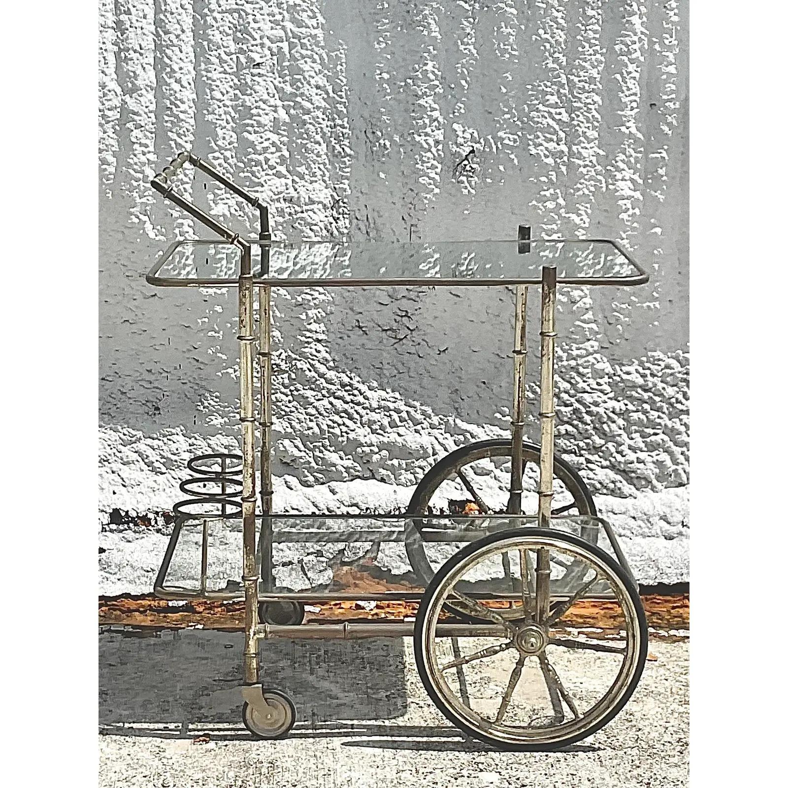 Fantastic vintage Regency bar cart. Beautiful silver plate bamboo frame with a mirrored top shelf. Three rings for your bottle service. Acquired from a Palm Beach estate.