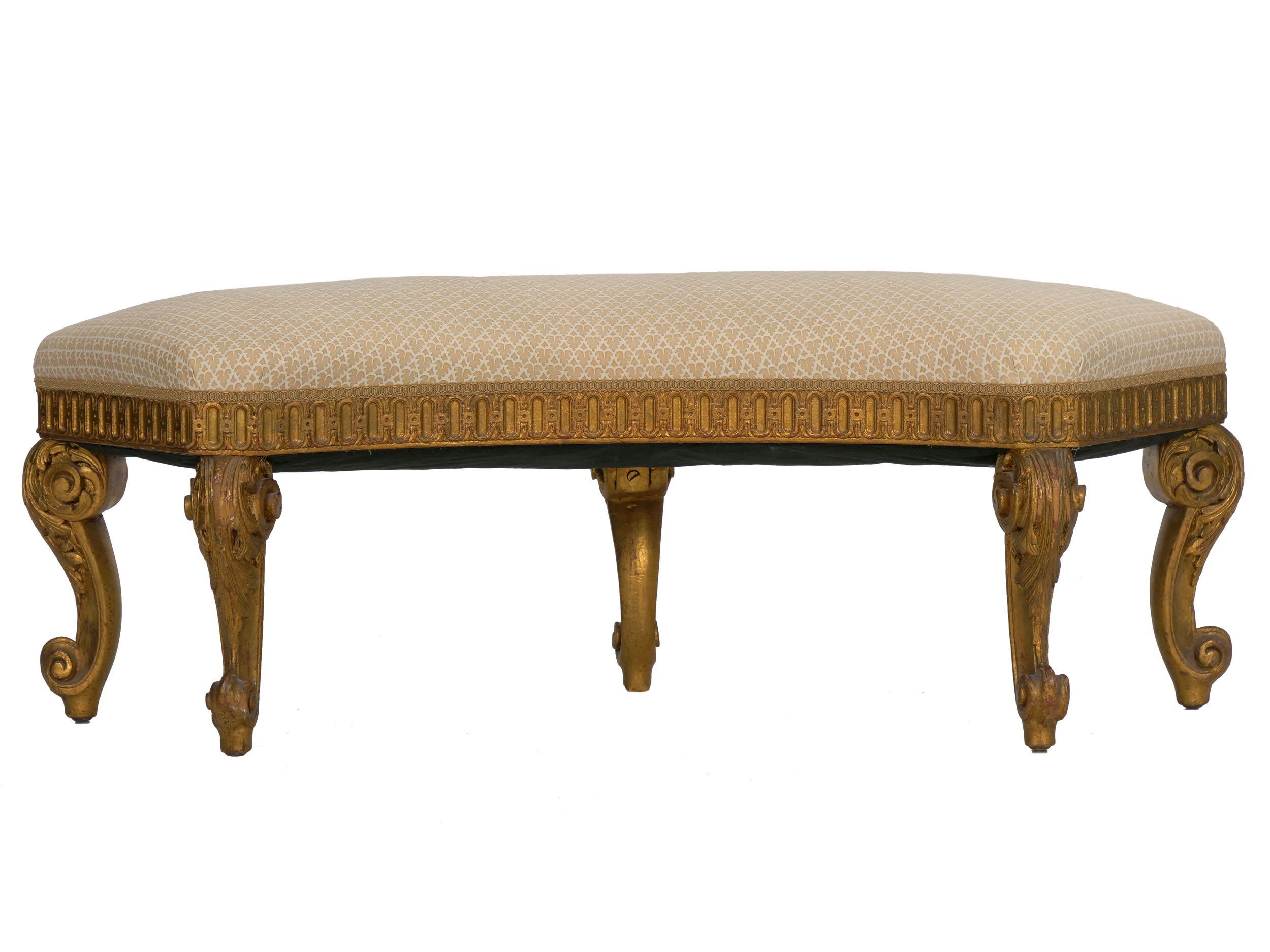 A quality Regency style reproduction crescent curved bench, the robust cabriole legs are attractively carved and gilded with hints of red bole showing through beneath faux and natural wear. There is strength and robustness in the form that is most