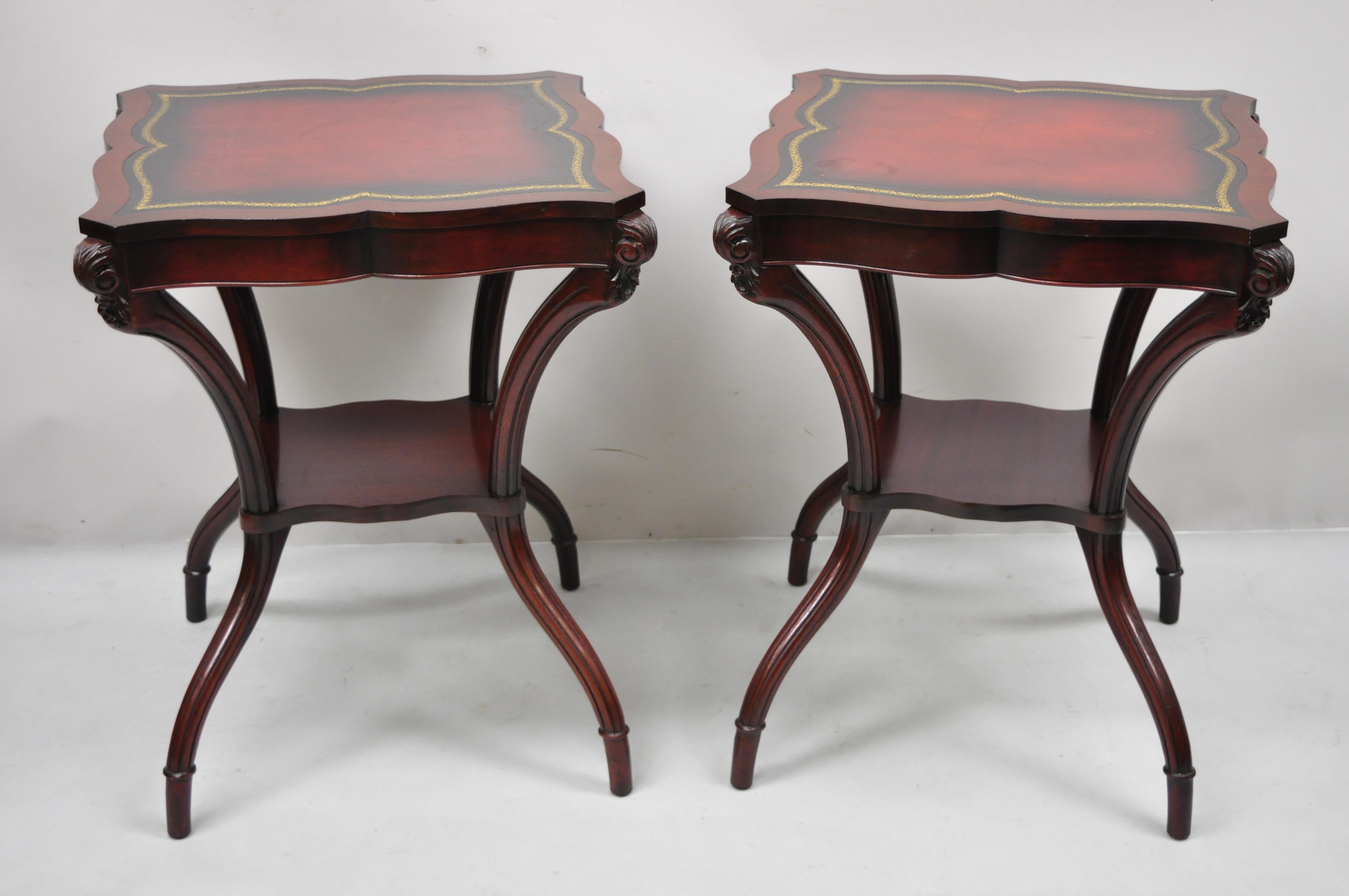 Vintage French Regency style red leather top mahogany lamp end tables - a pair. Item features red tooled leather tops, lower shelf, solid wood frame, beautiful wood grain, very nice vintage pair, great style and form. Circa Mid 20th Century.