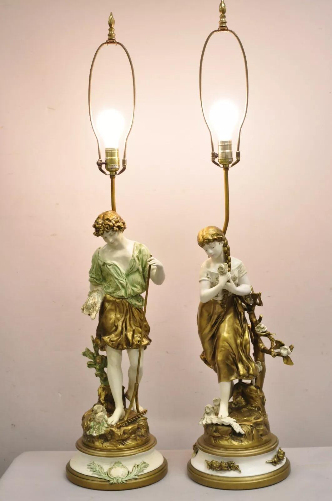 Vintage French Renaissance L.F. Moreau Cast Spelter Metal Boy and Girl Figural Table Lamps in White, Gold, and Blue - a Pair (Slight difference in base design). Circa Early 20th Century. Measurements: 43.5