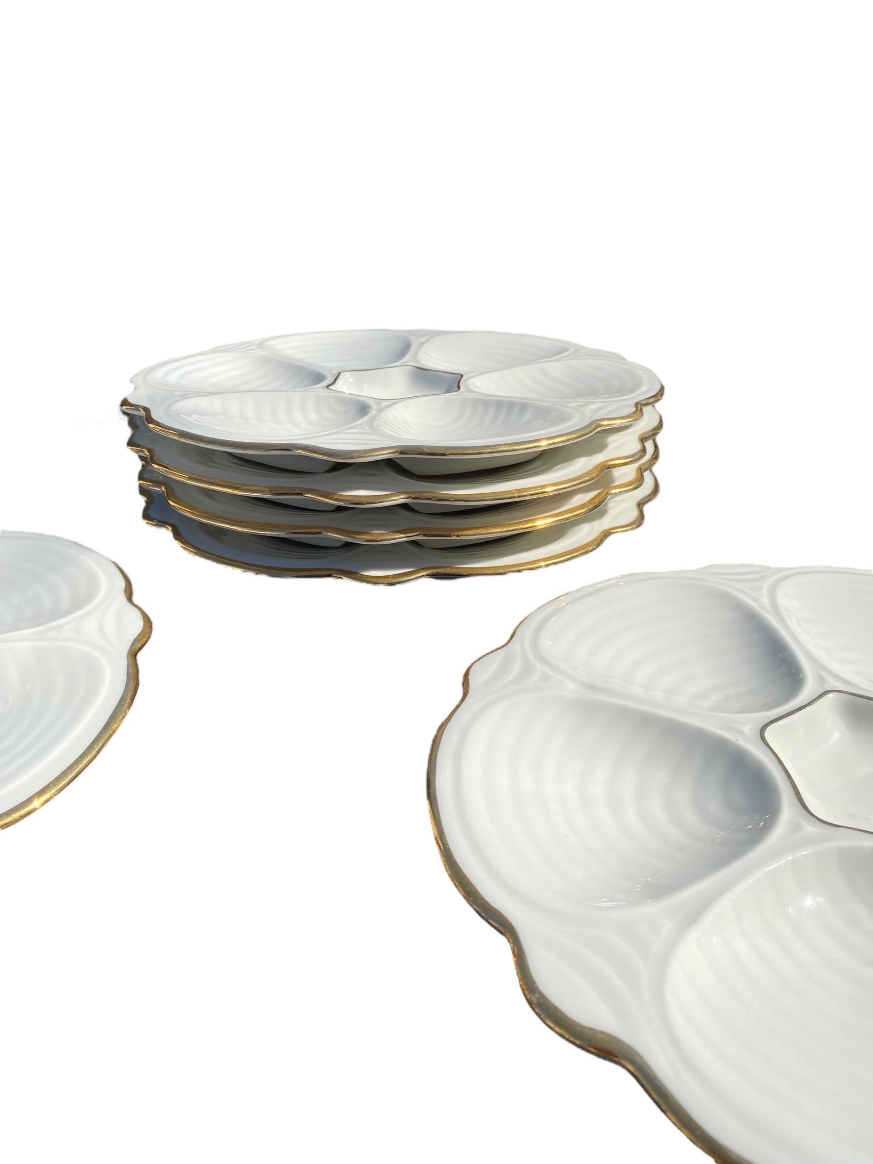 A set of six vintage French white with gold oyster plates from a charming French restaurant, Au Cadet De Gascogne in Montmartre, Paris, France. Elegant yet understated, they set a chic French table for your next gathering of friends and family. They
