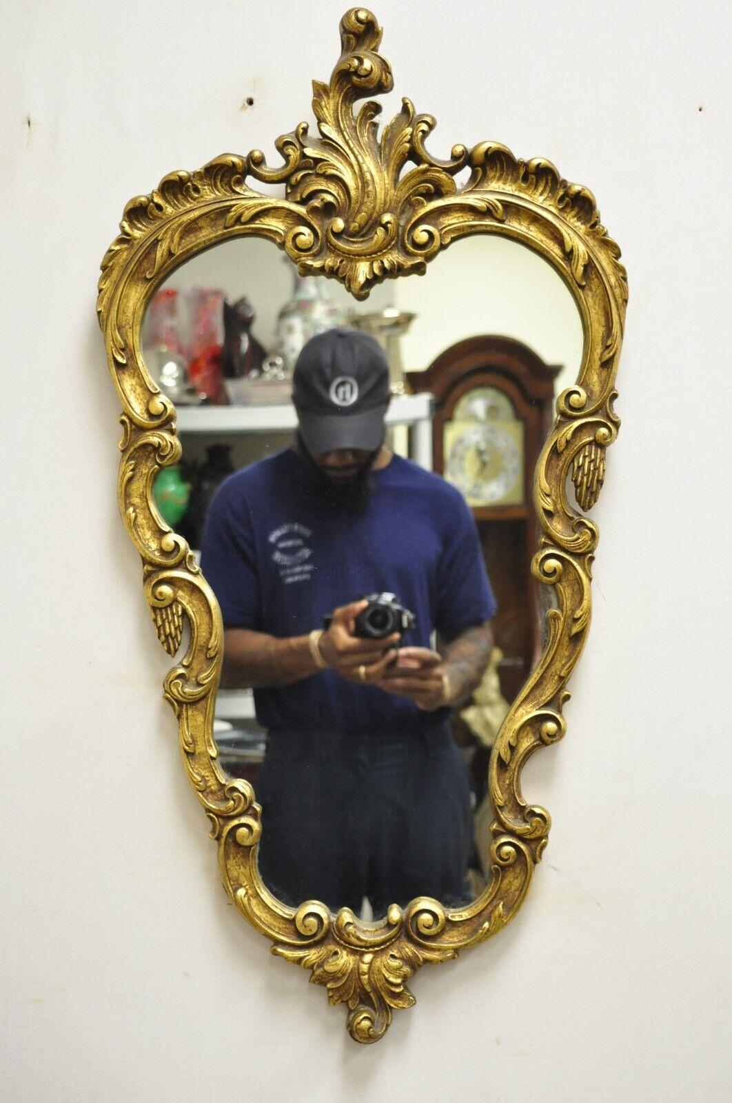 Vintage French Rococo Style Gold Gilt Leafy Scrollwork Wall Mirror. Circa Mid 20th Century. Measurements: 34.5