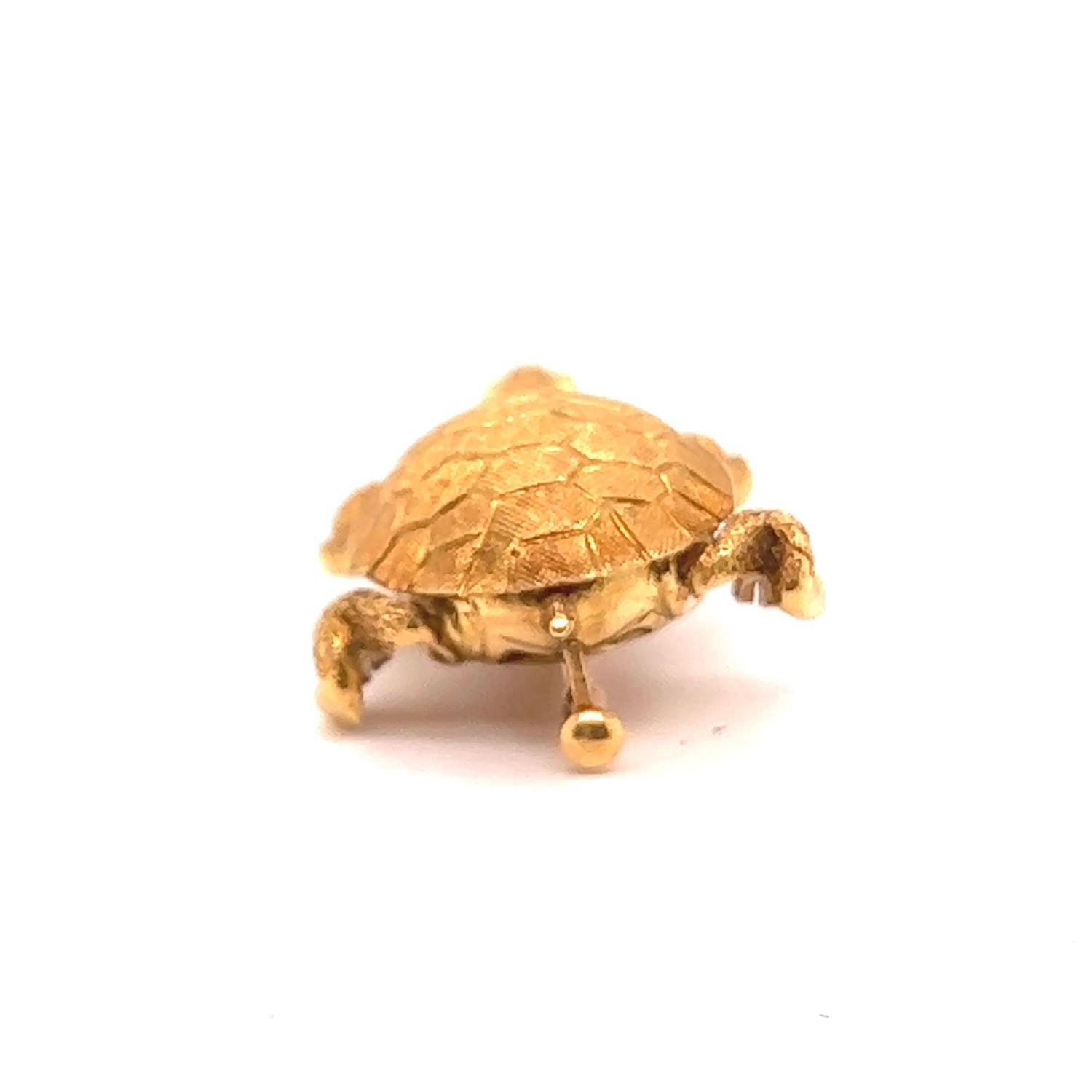 One Vintage French Sapphire 18 Karat Yellow Gold Turtle Brooch. Featuring two round sapphire with a total weight of approx 0.20 carats.Crafted in 18 karat yellow gold with French import marks. Circa 1960s. The brooch measures 1 1/2 by 1 inch.