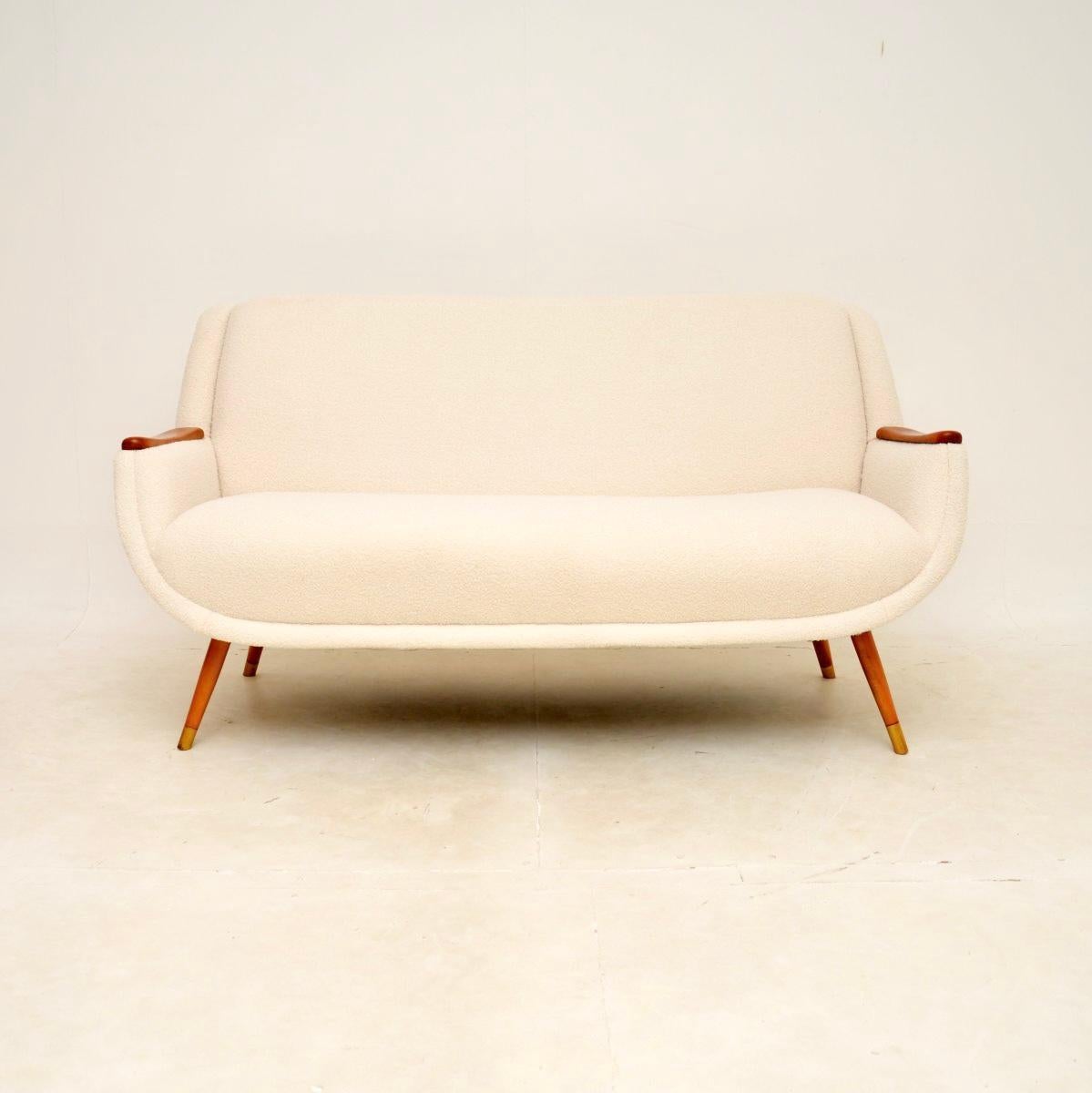 A stylish and very comfortable vintage French satin wood sofa. This was recently imported from France, it dates from the 1950-60’s.

This is extremely well made, the quality is outstanding. The frame is well sprung and generous to relax in, the