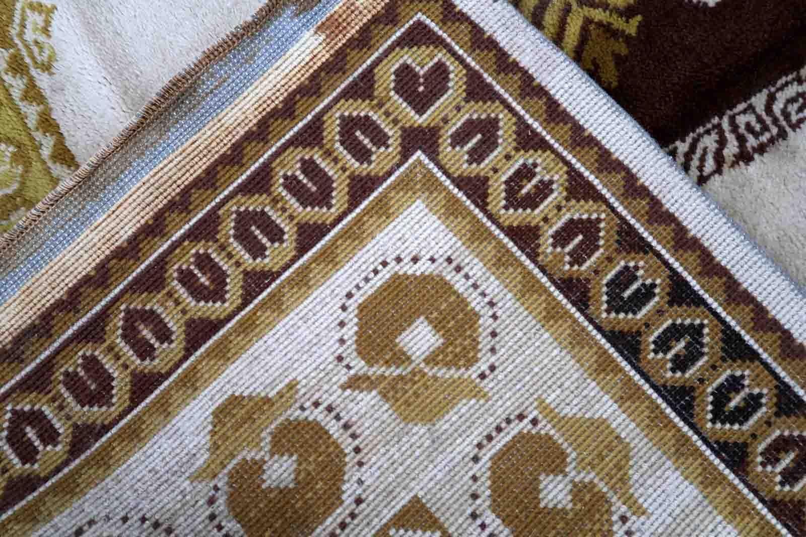 Vintage French Savonnerie rug in beige, brown and golden shades. The rug is from the middle of 20th century in original good condition.

-condition: original good,

-circa: 1950s,

-size: 7.9' x 11.4' (242cm x 349cm),

-material:
